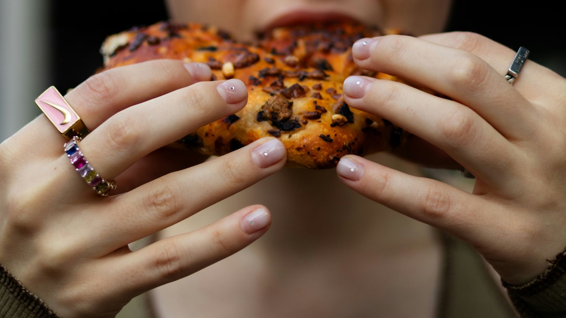 a woman holding a piece of food in her hands