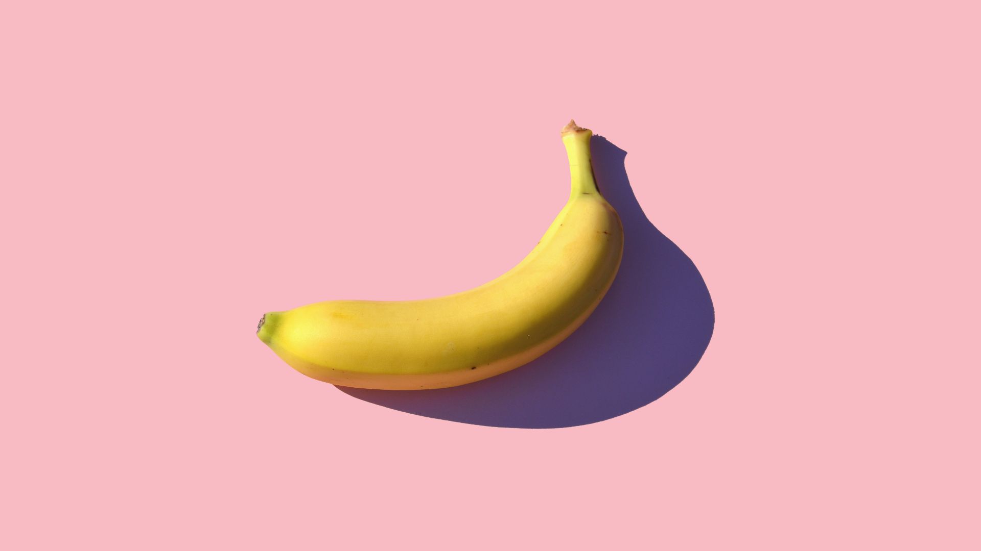 riped banana on pink surface