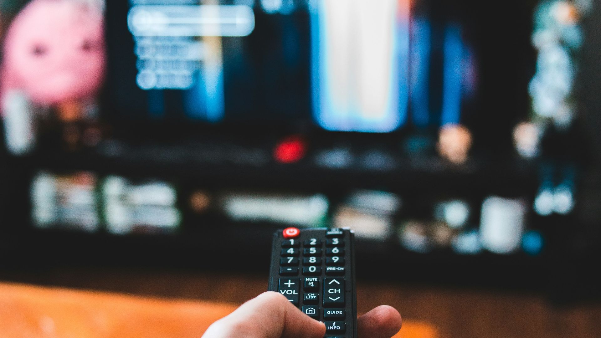 person holding black remote control