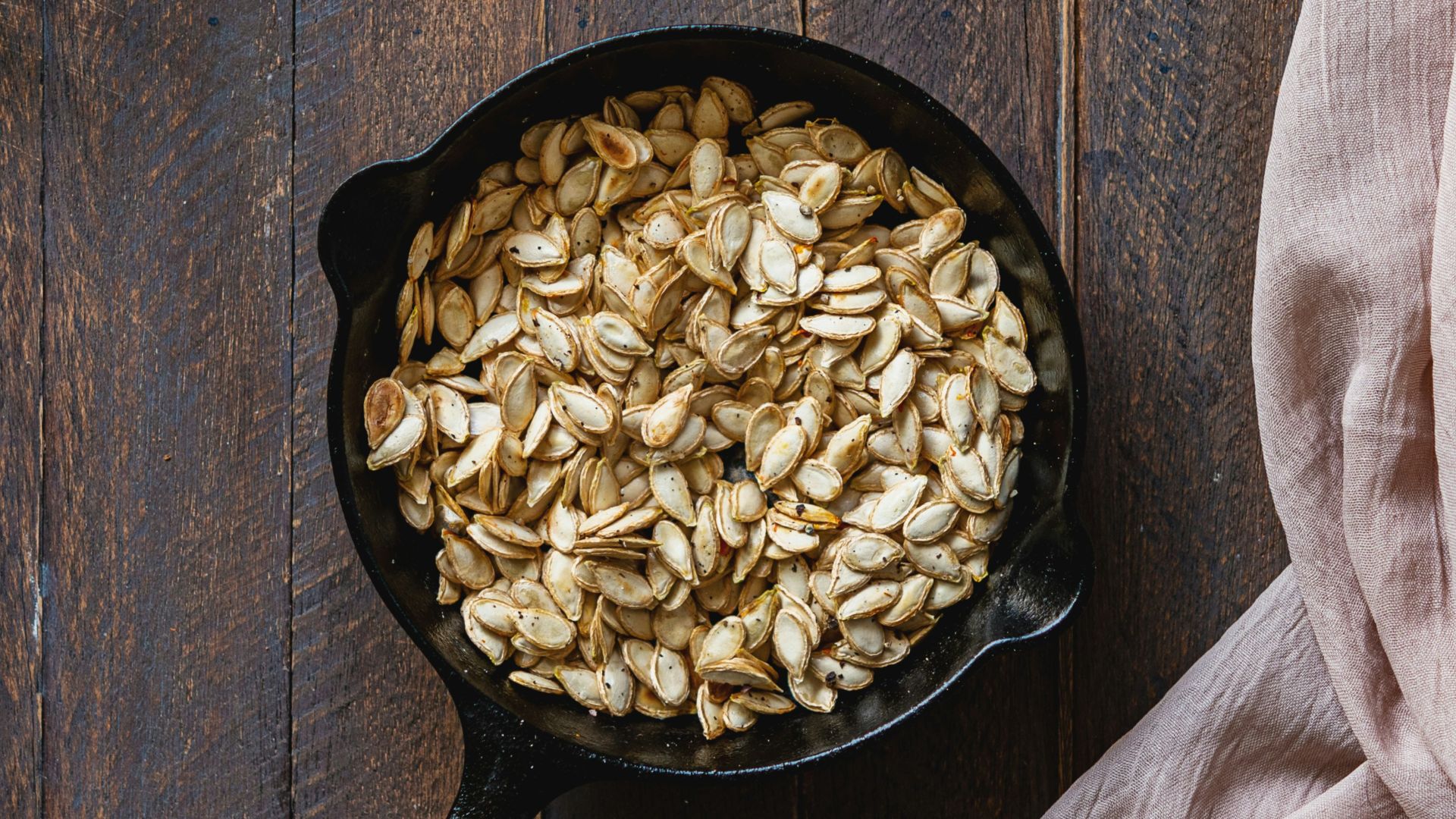 black cast iron pan with brown wooden handle