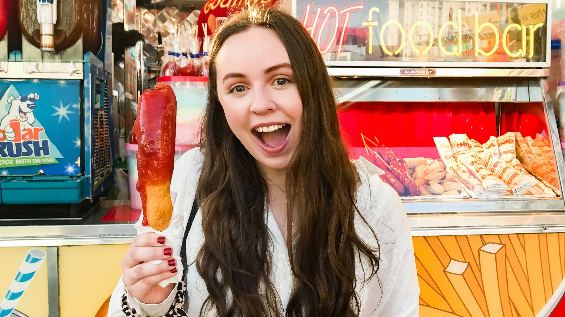 woman in white cardigan near food bar