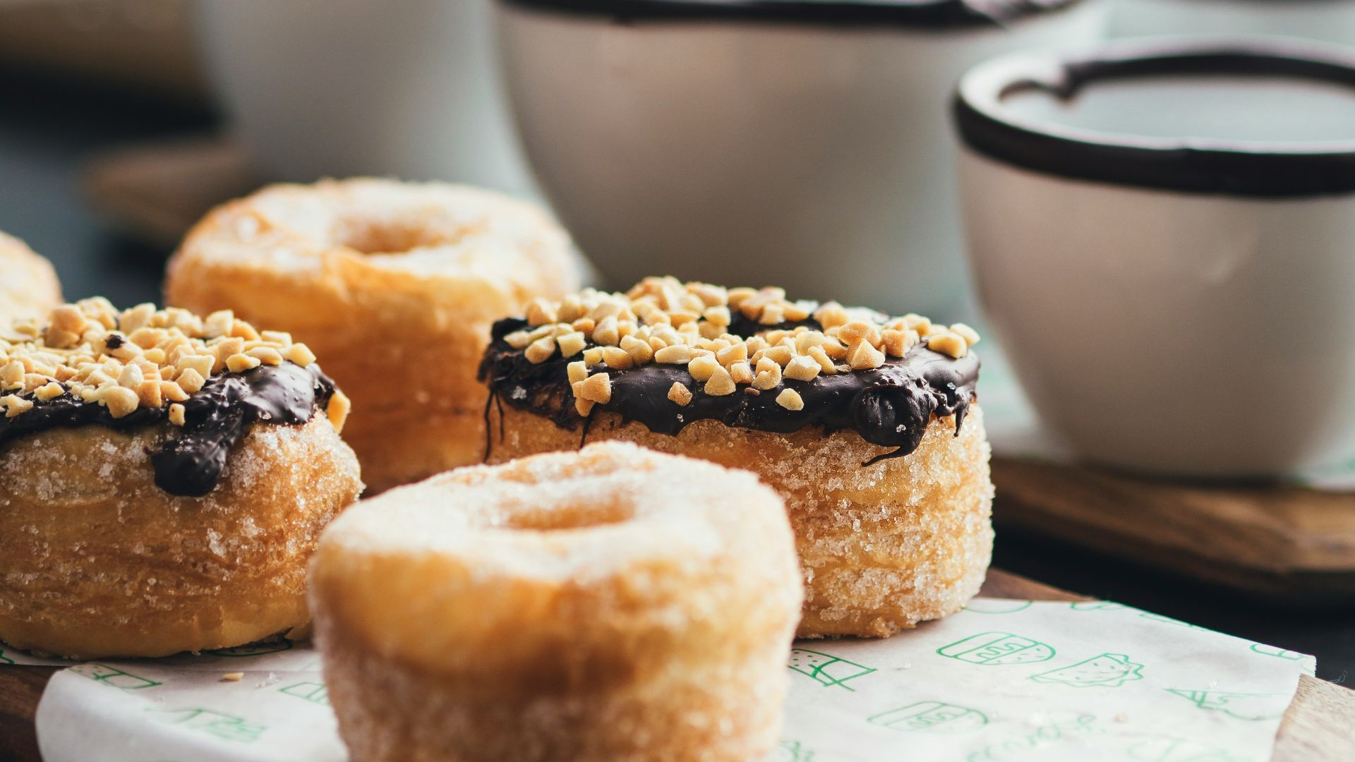 doughnuts topped with chocolate and peanuts selective focus photography