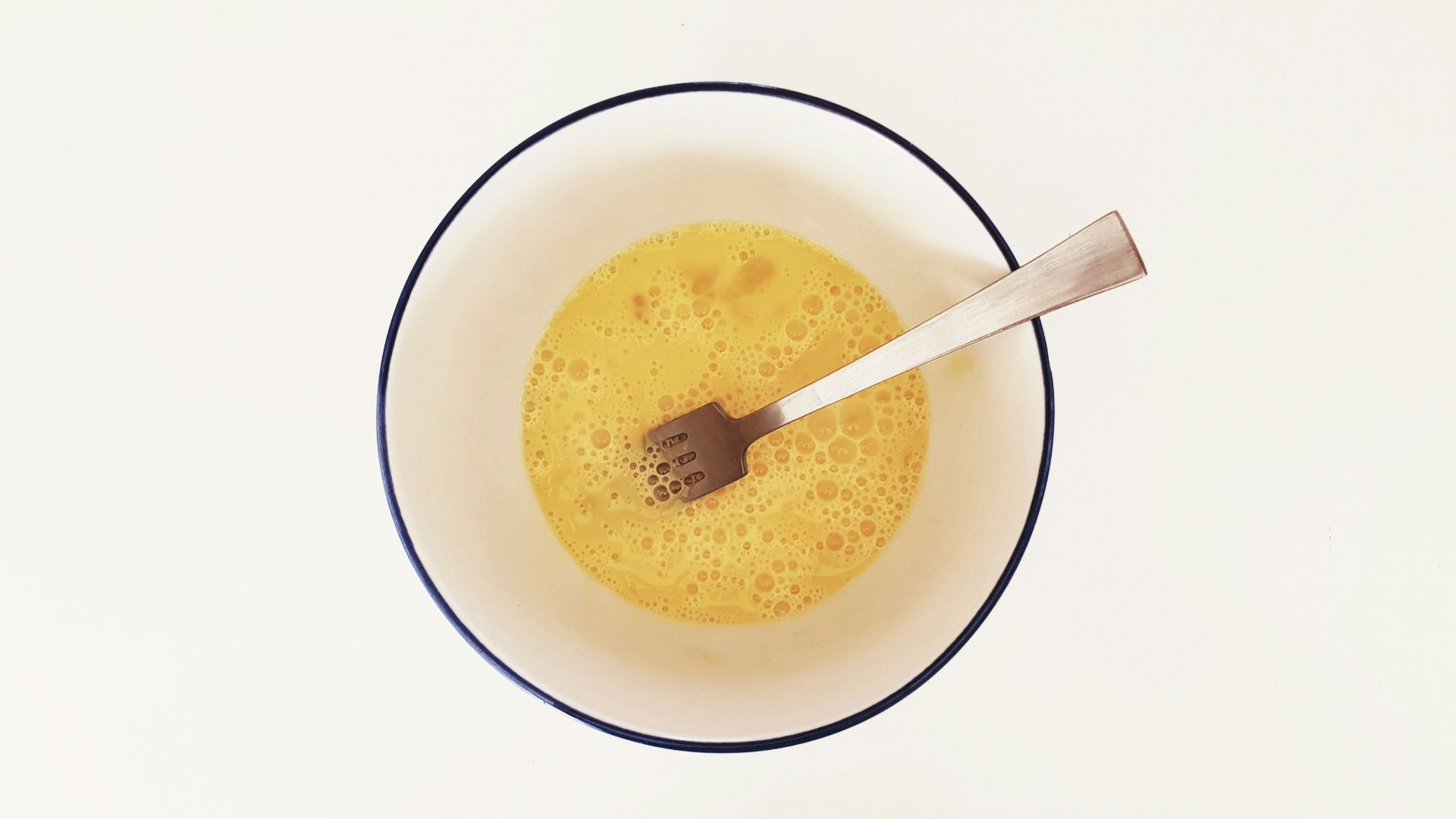 yellow beverage inside cup