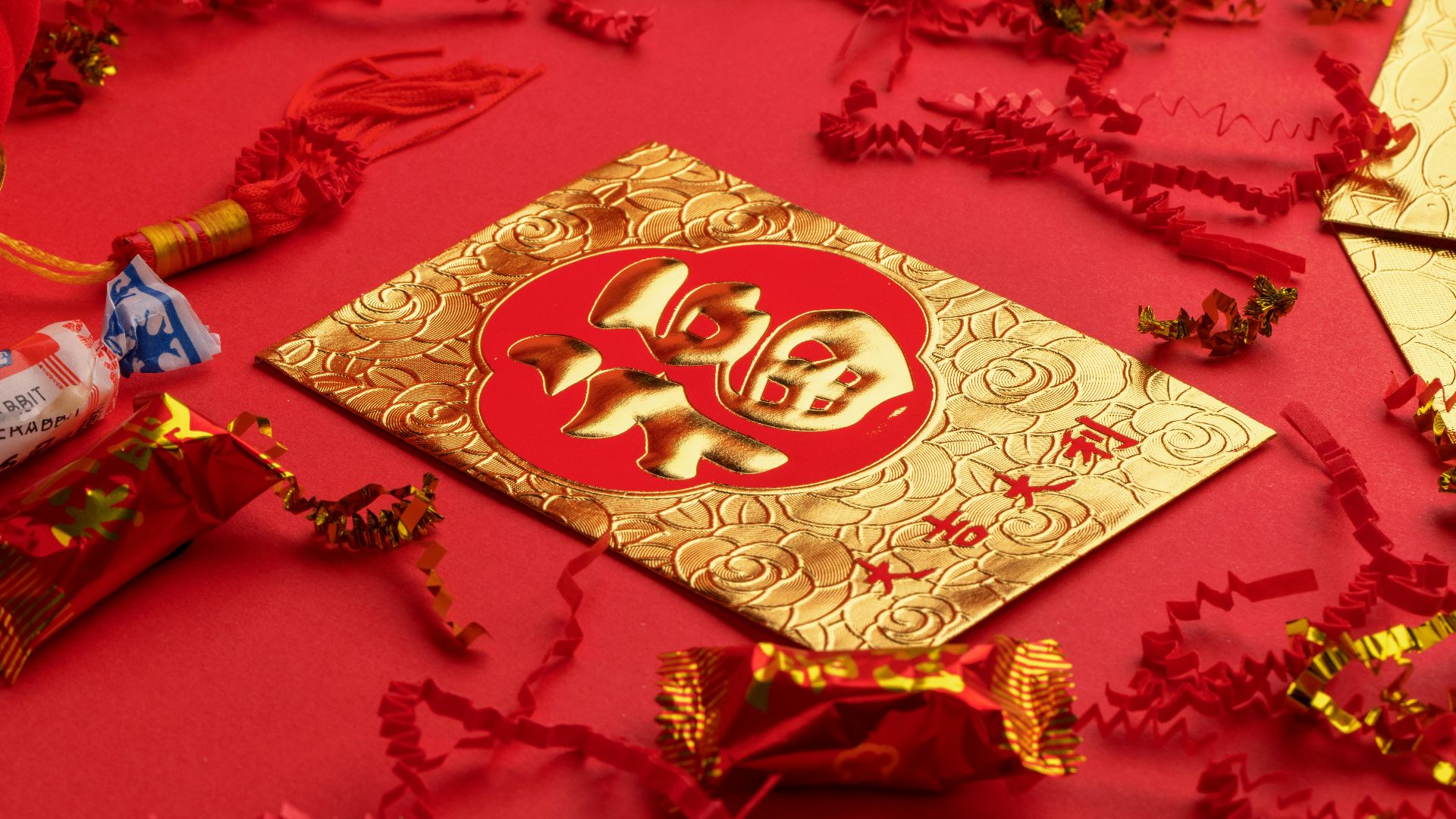 gold and white religious print book on red textile