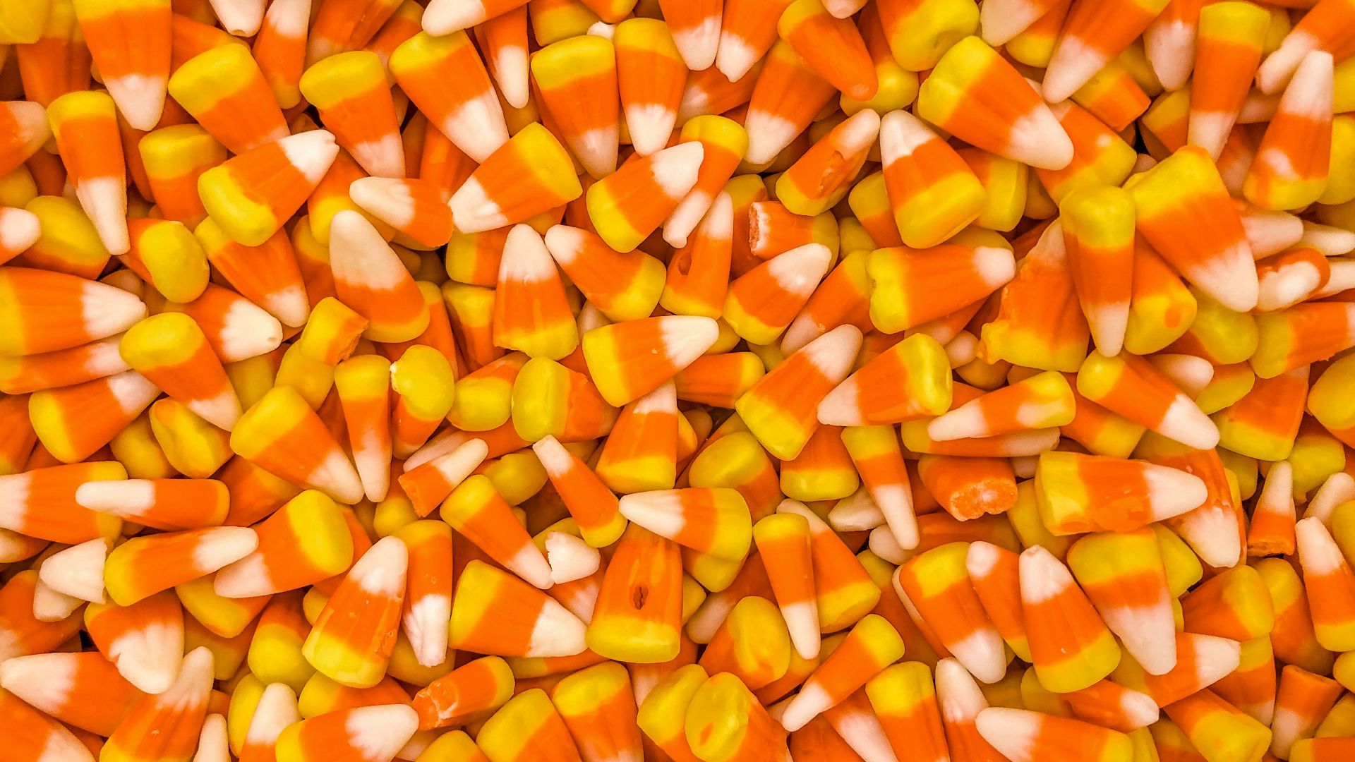 a pile of orange and white candy corn