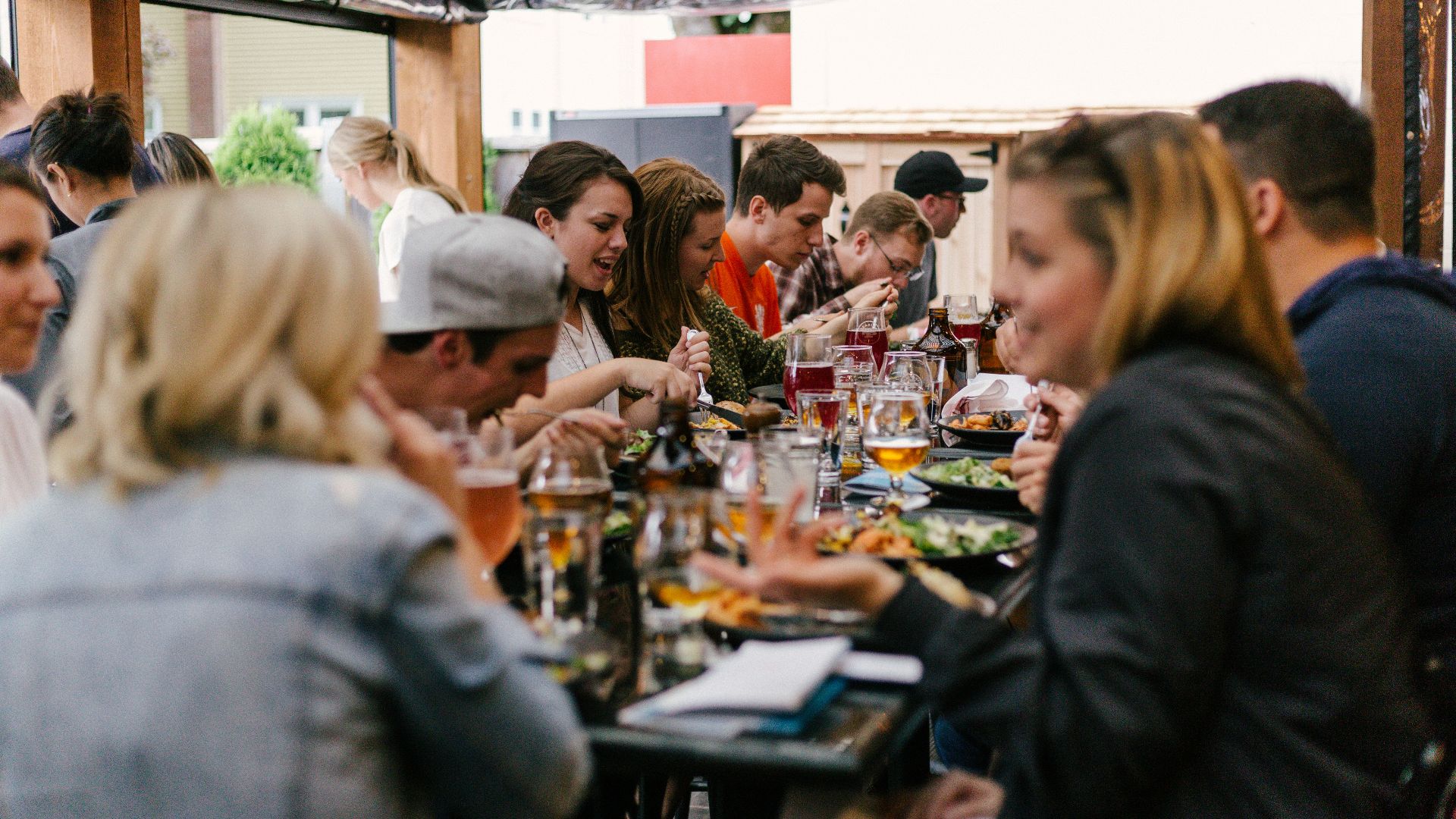 people sitting in front of table talking and eating