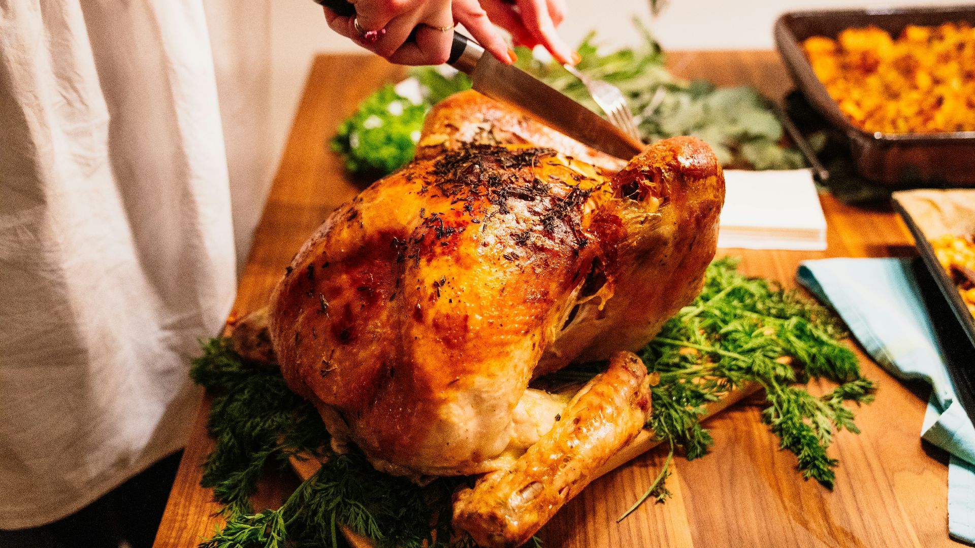 person about to slice the roasted chicken