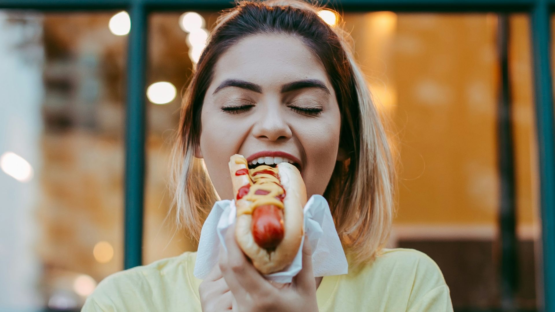 woman in white crew neck t-shirt eating apple