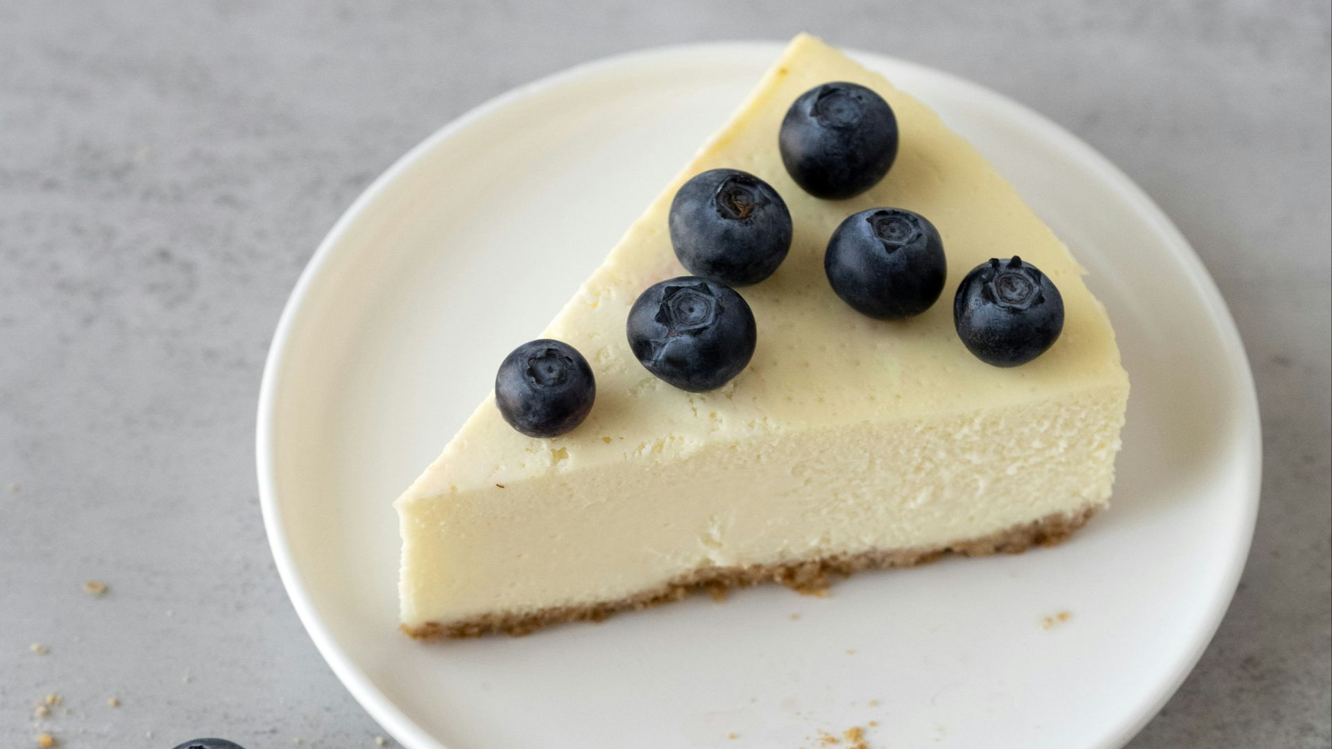 a slice of cheesecake with blueberries on a plate