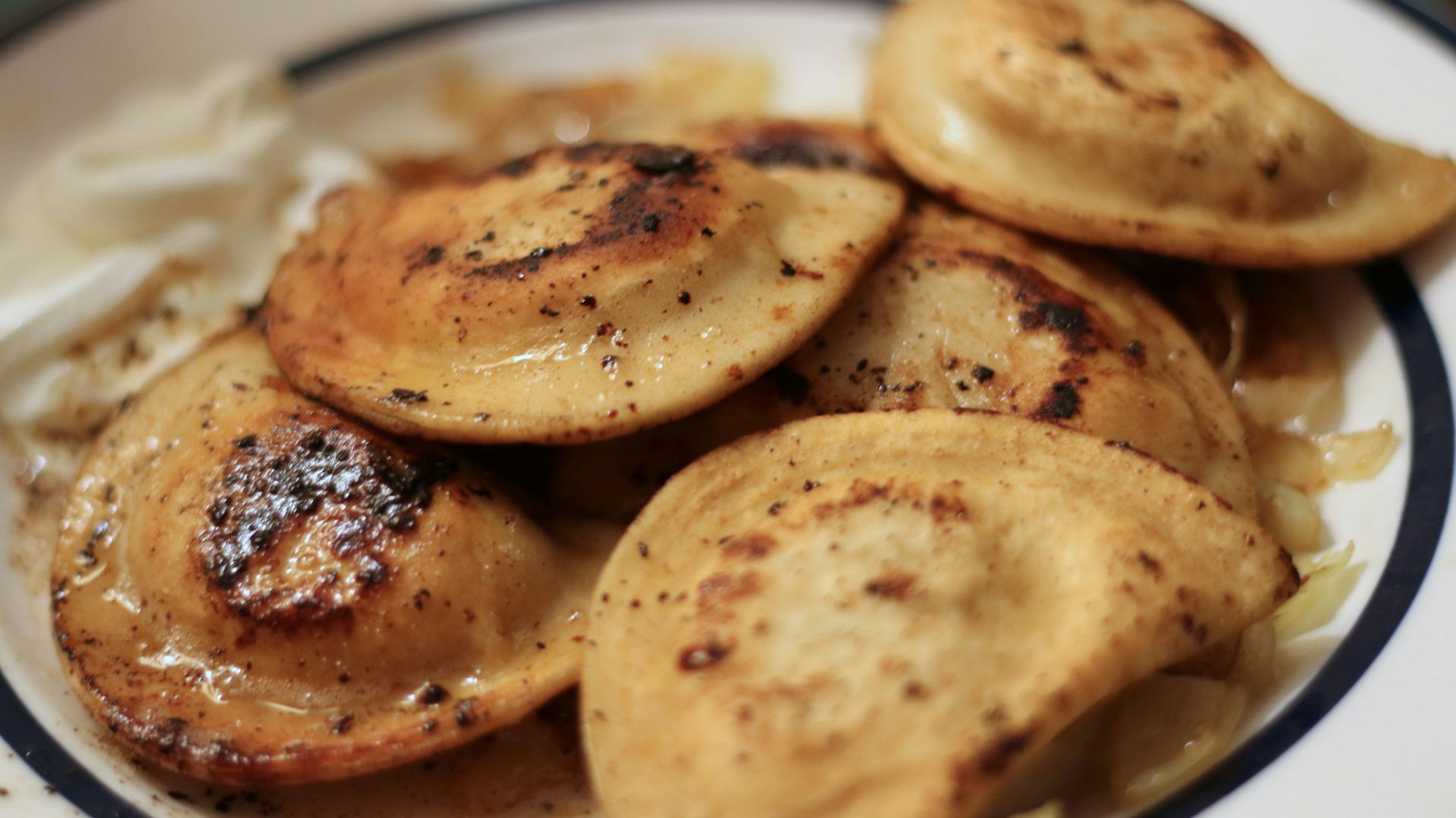 a white plate topped with potatoes and gravy