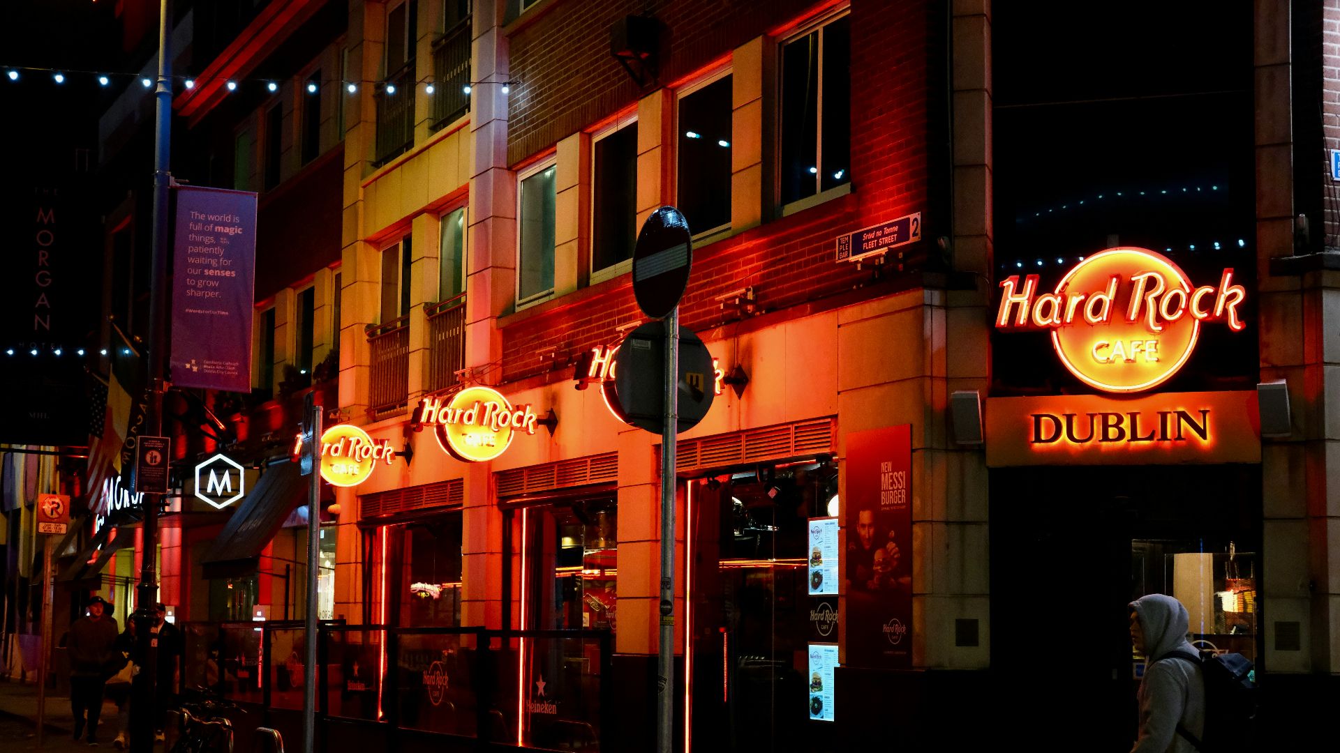 a person walking down a street at night