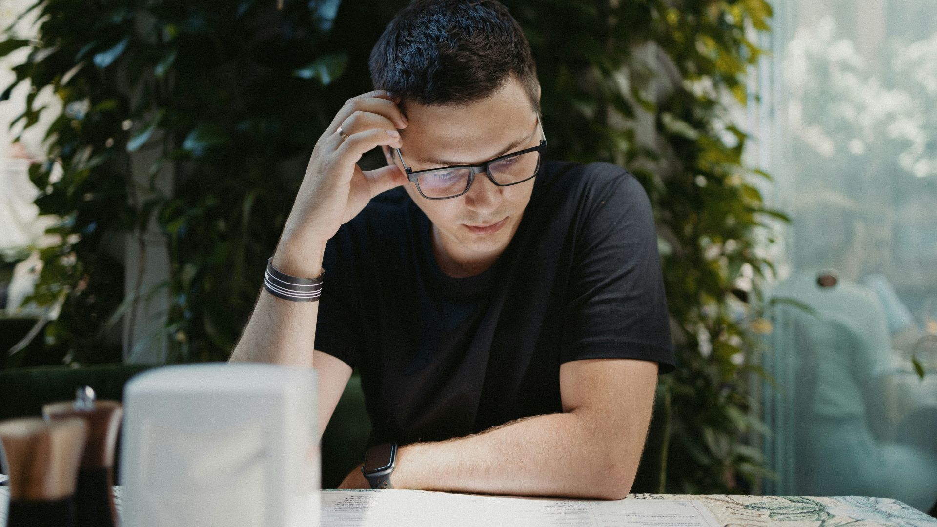 man in black crew neck t-shirt wearing black framed eyeglasses