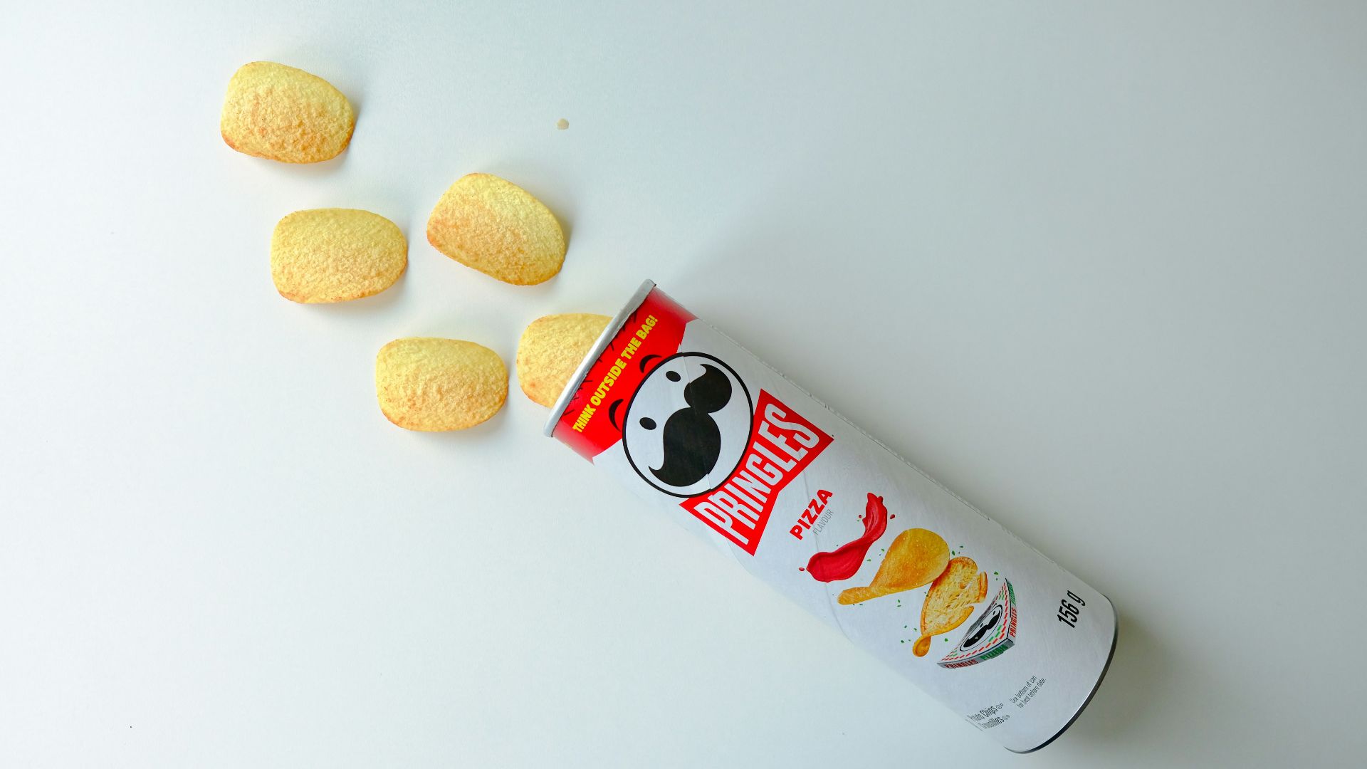 a can of macaroni and cheese on a white surface