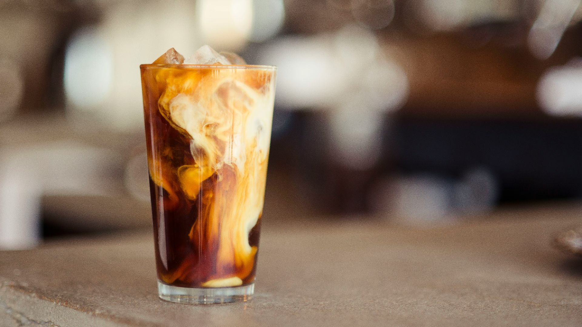 glass cup filled with ice latte on tabletop