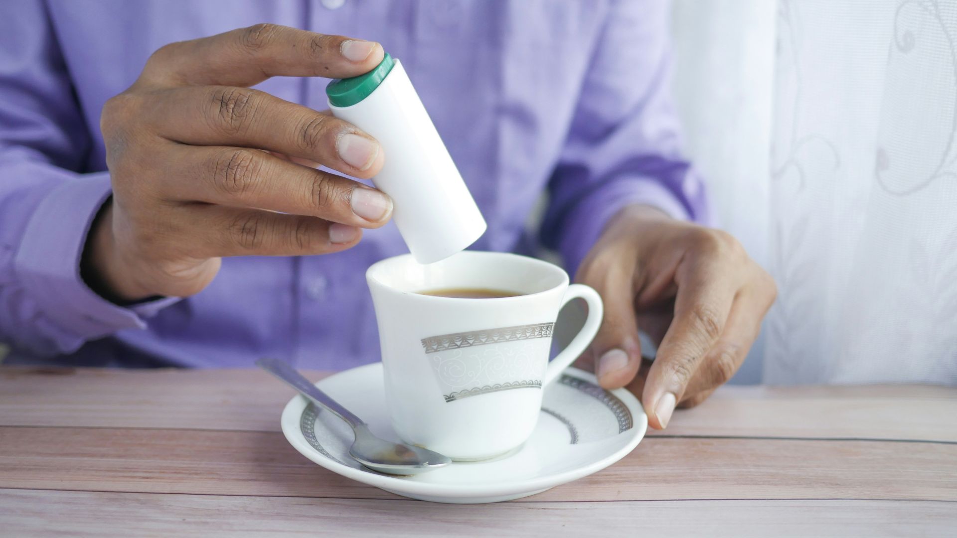 person holding white ceramic mug