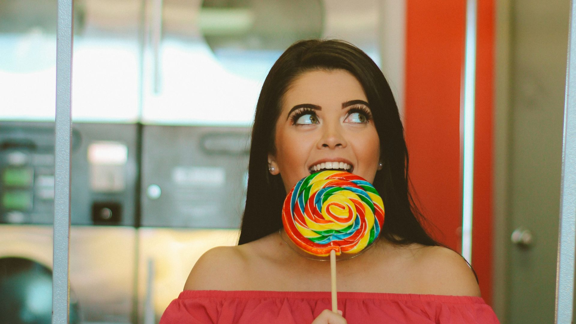 woman holding lollipop inside basket