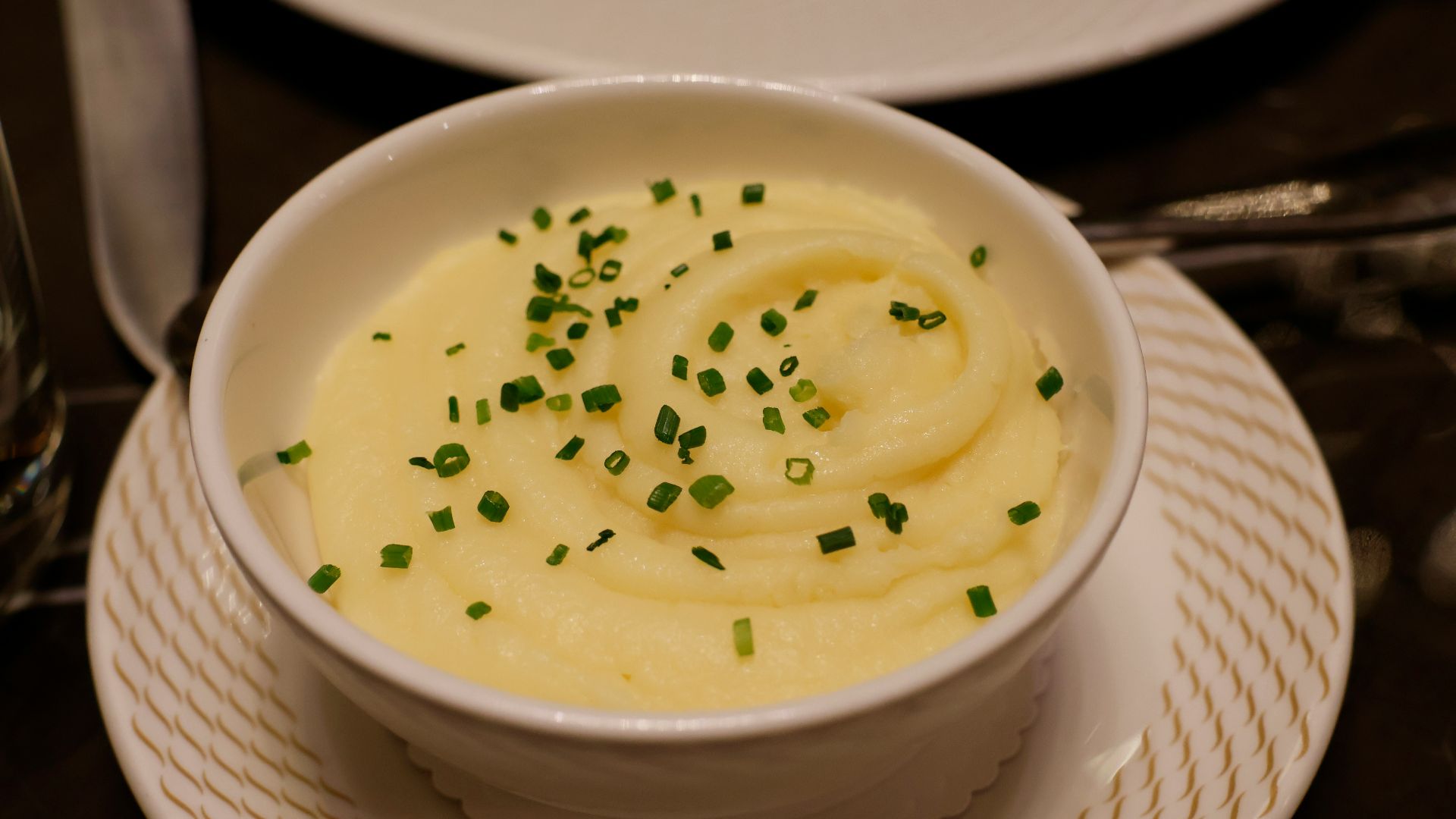 a bowl of mashed potatoes topped with chives