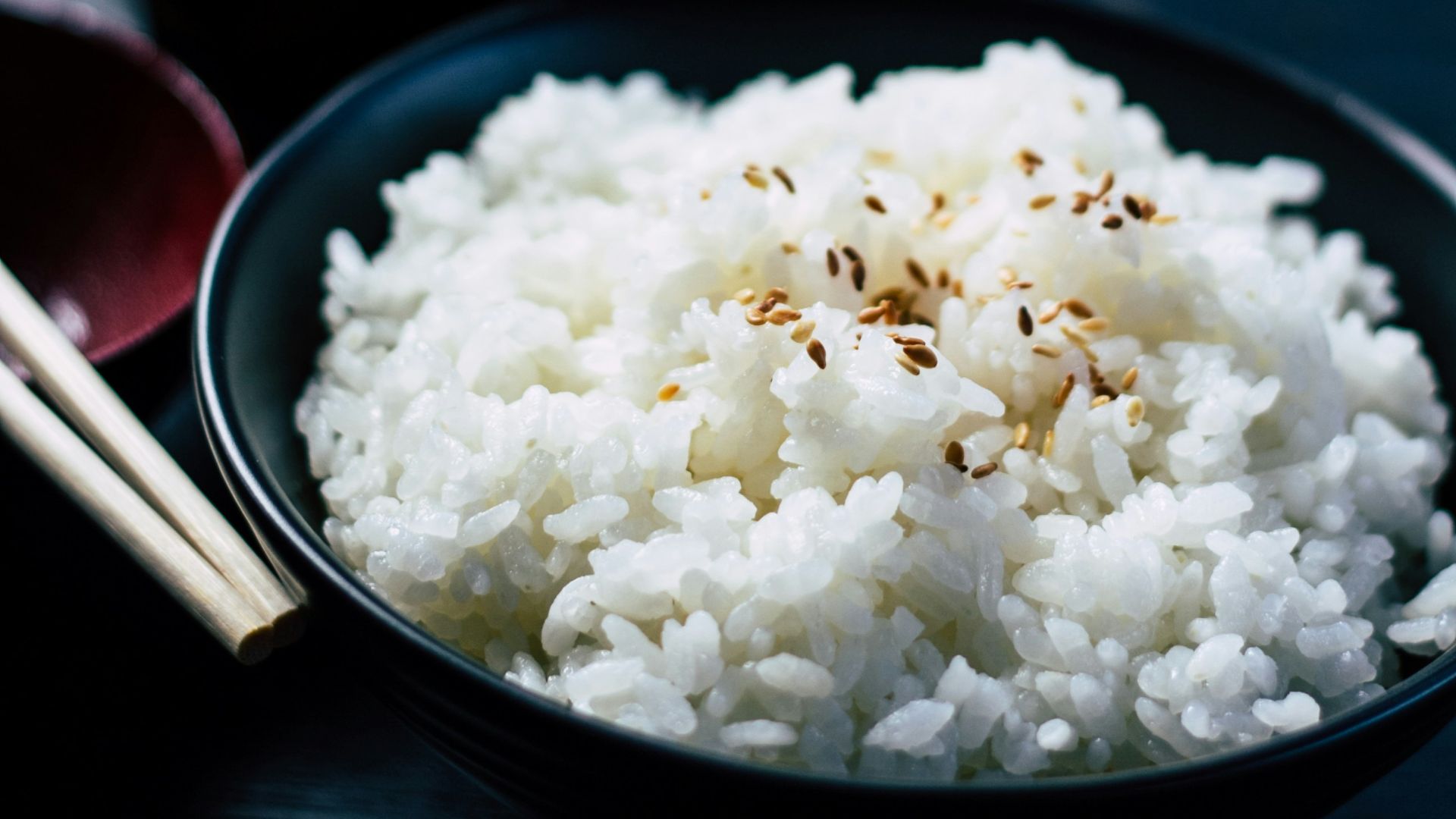 rice with sesame in black bowl
