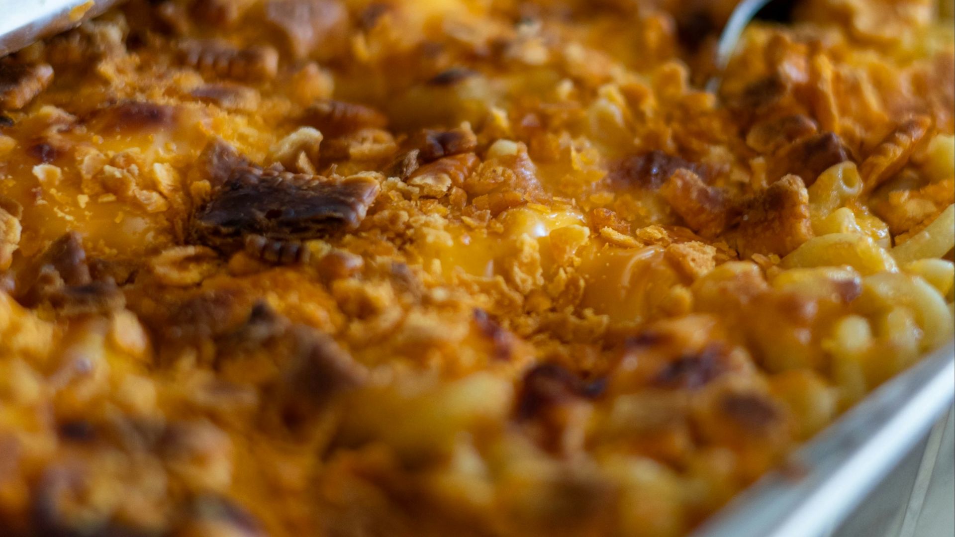 a dish of macaroni and cheese with a spoon in it