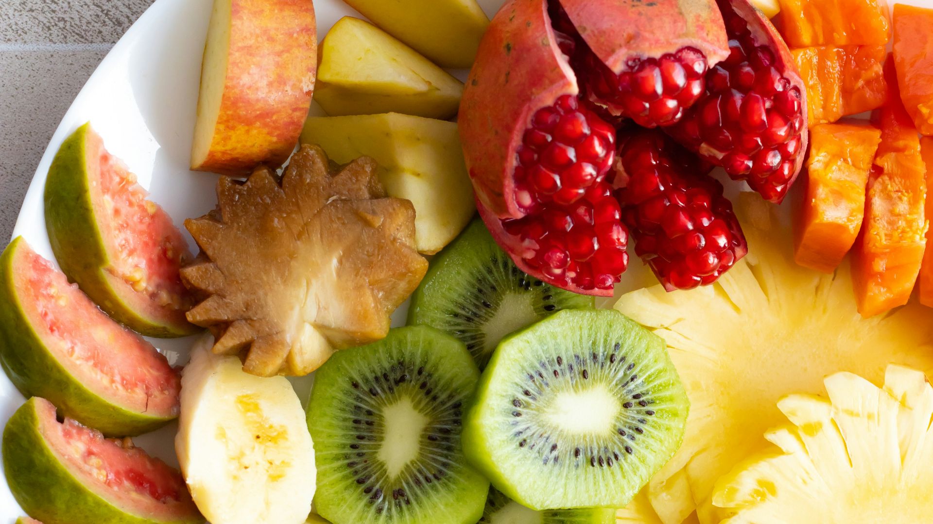 a white plate topped with cut up fruit