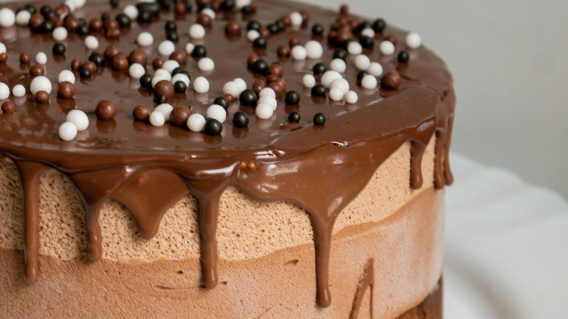 chocolate cake with white icing on white ceramic plate