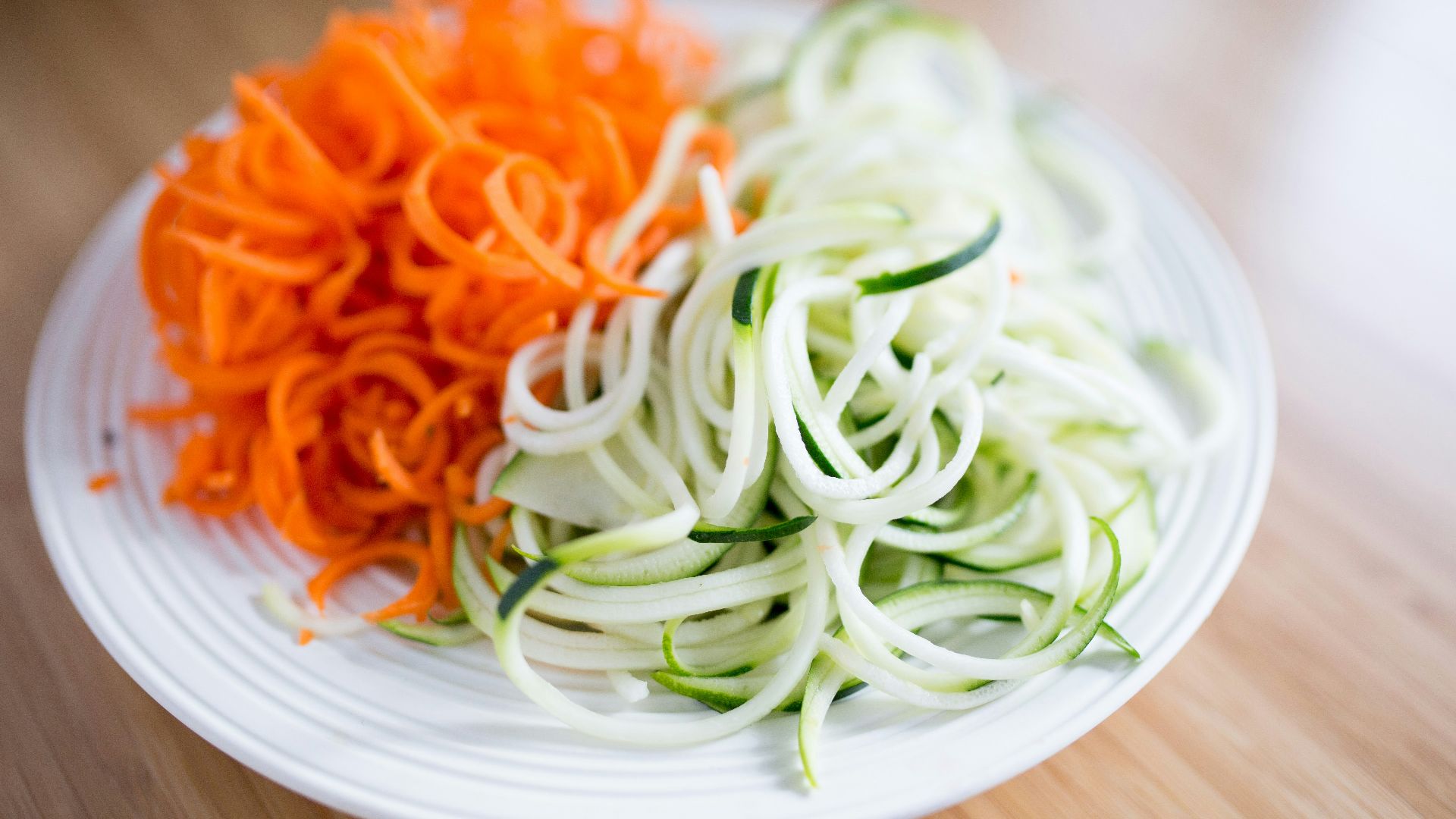 round white ceramic plate with sliced vegetables