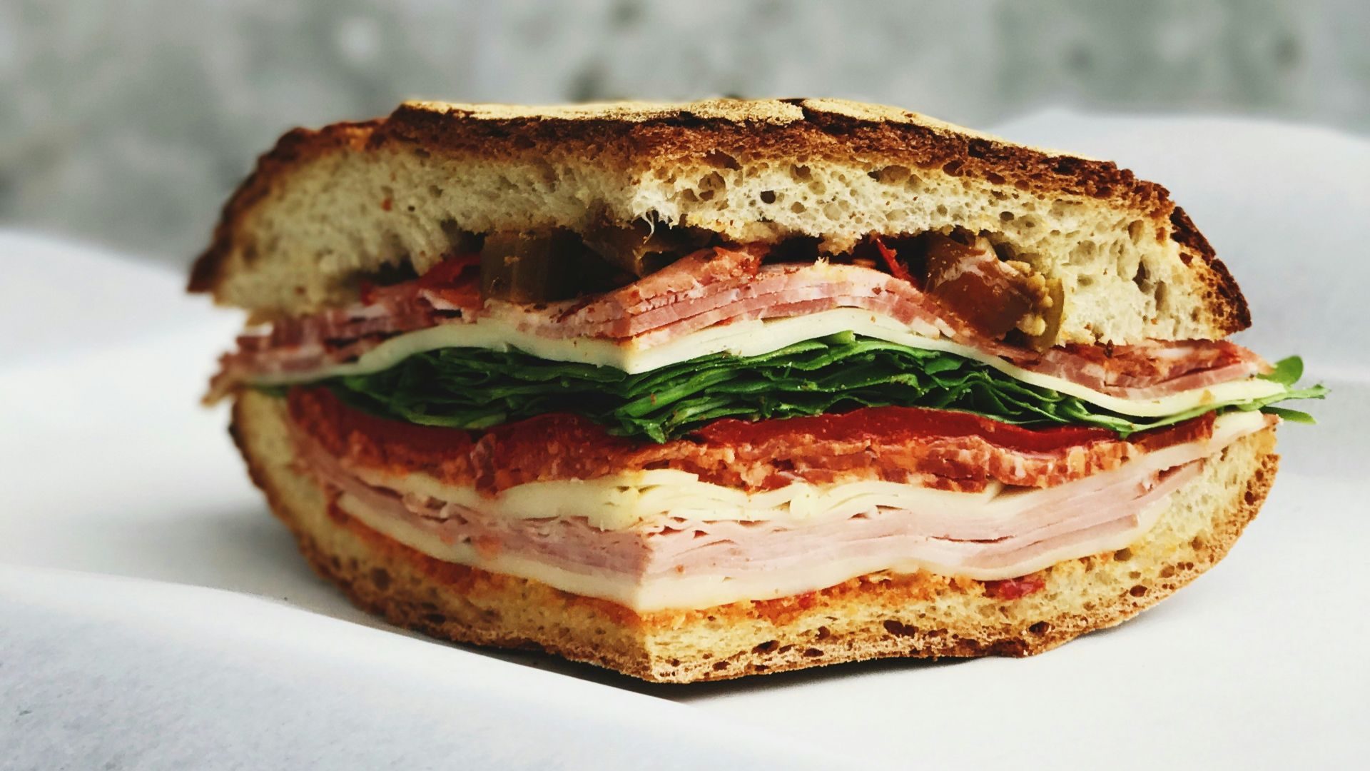 ham sandwich on white surface