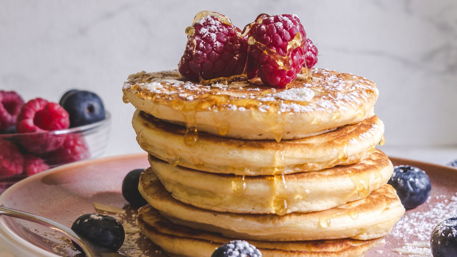 pancakes with berries on white ceramic plate
