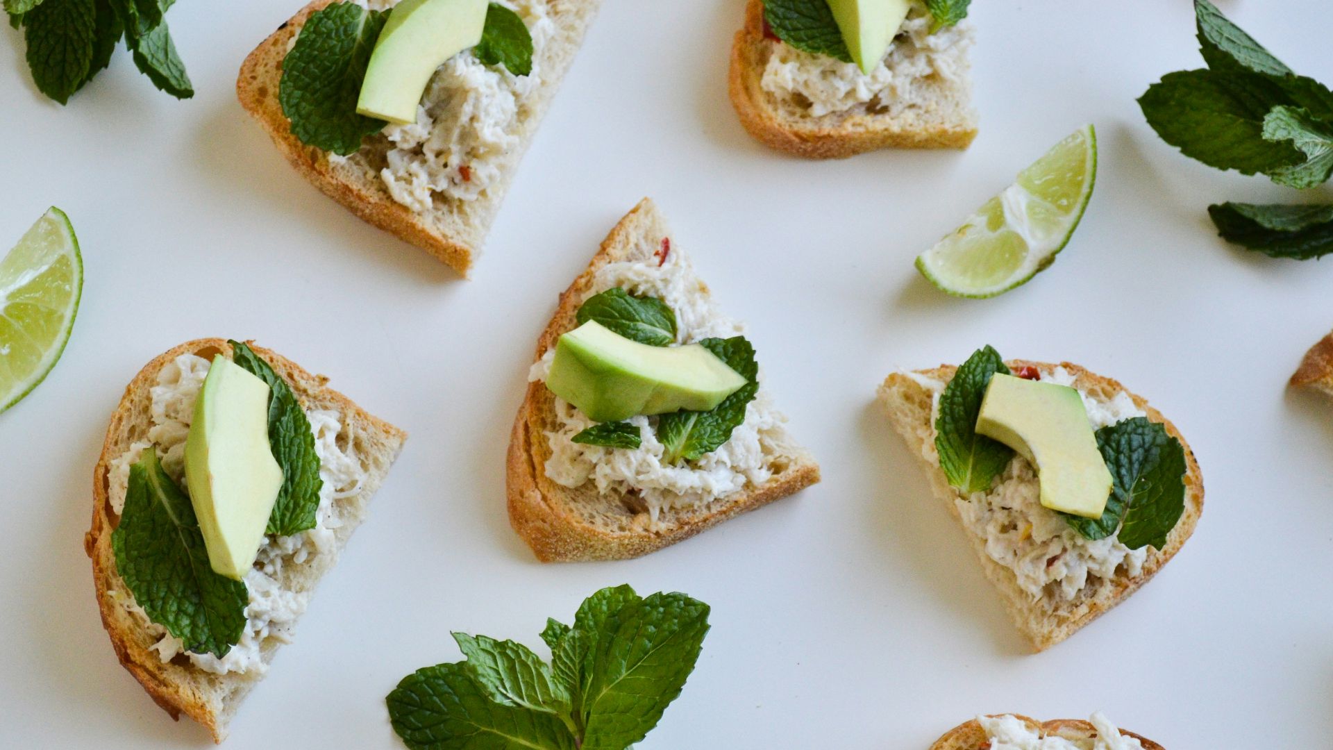 a table topped with slices of bread covered in toppings