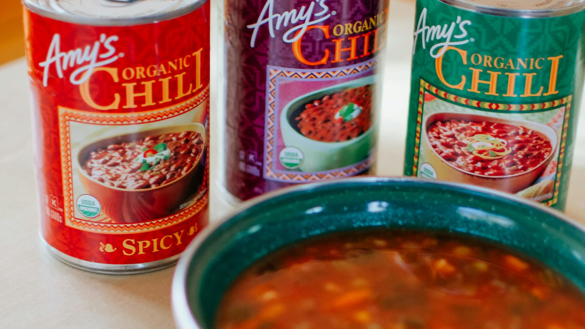 red and white labeled can beside stainless steel spoon