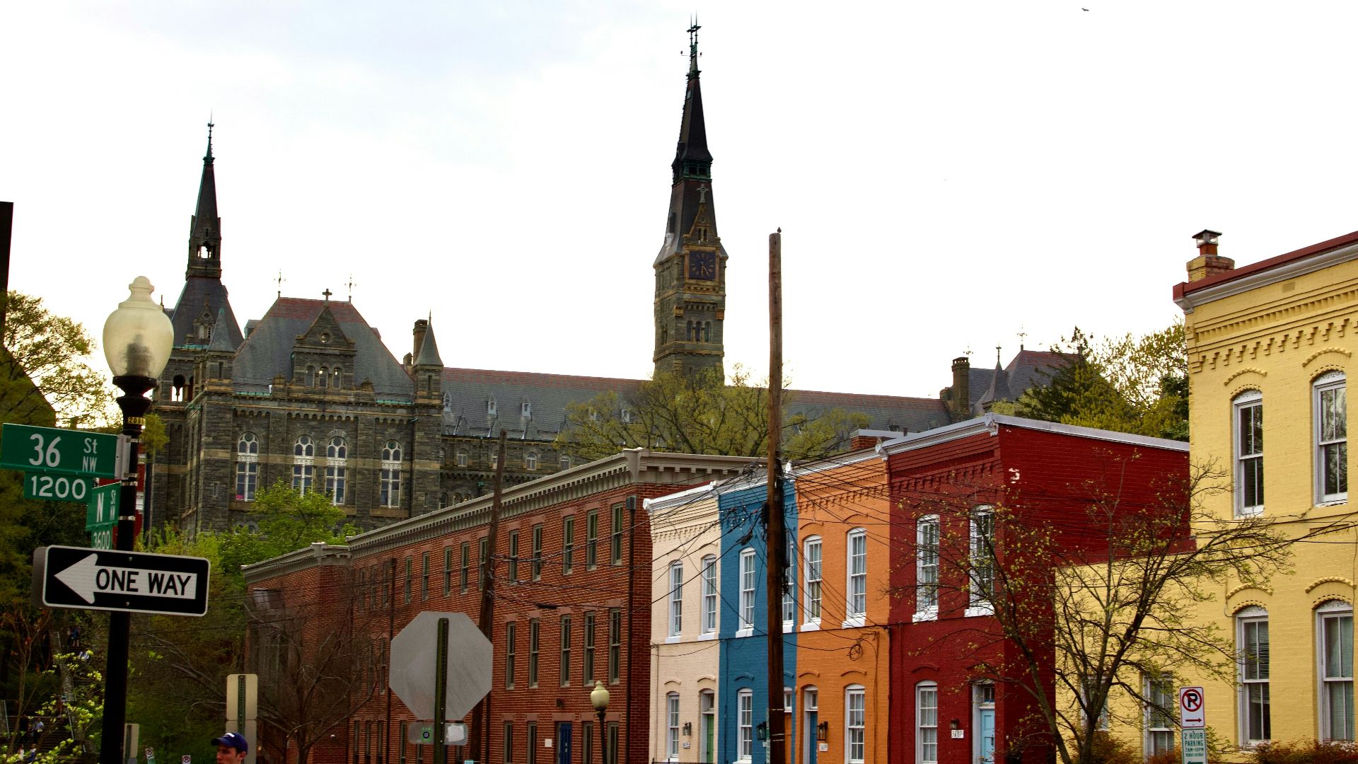 a city street with a church steeple in the background