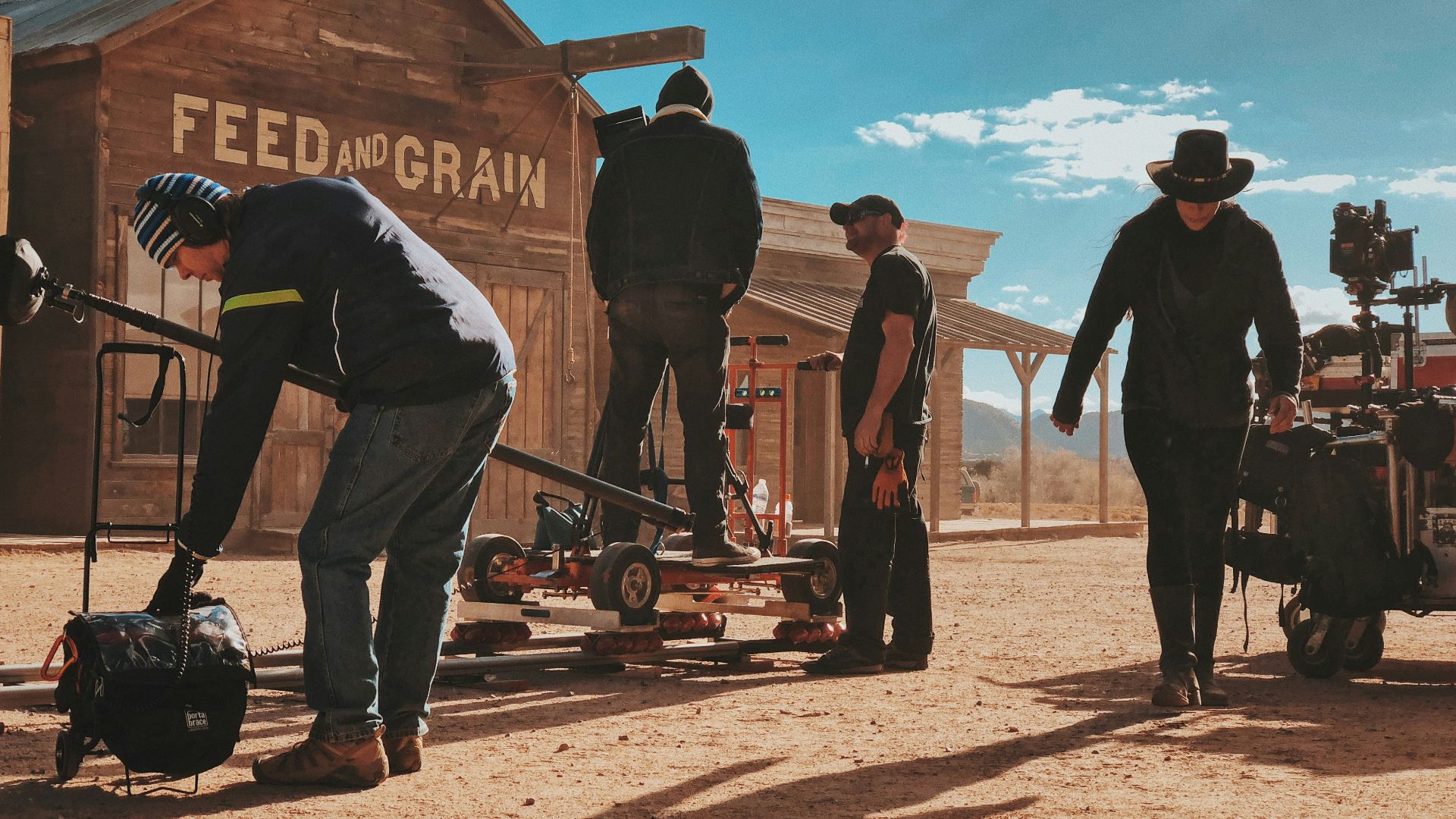 four men standing outside Feed and Grain store