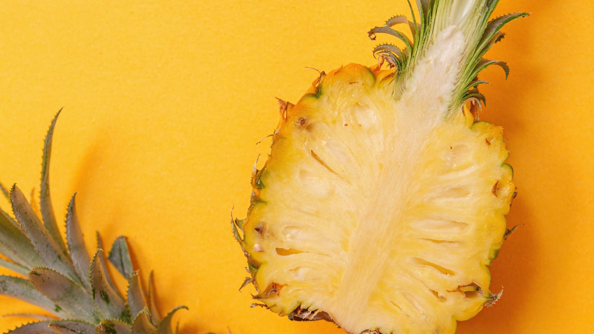pineapple fruit on yellow surface