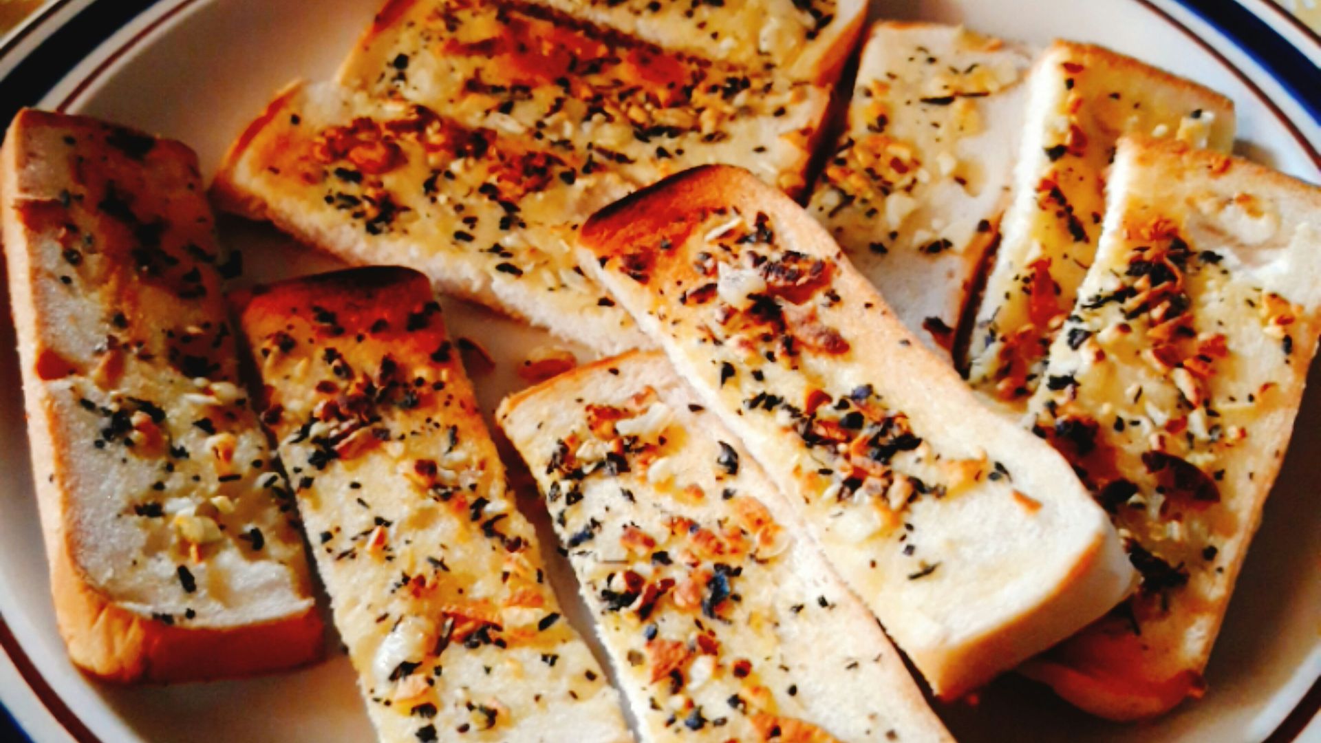 sliced pizza on blue and white ceramic plate