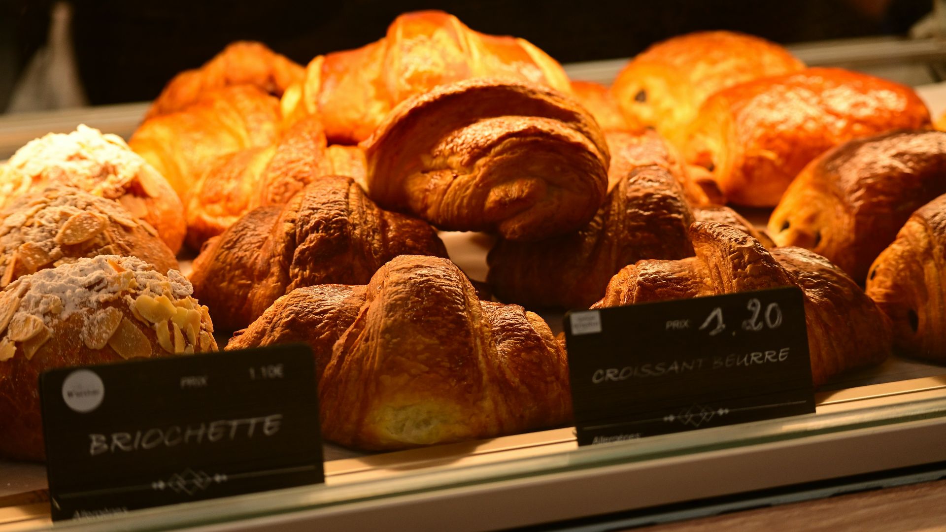 A display case filled with lots of baked goods