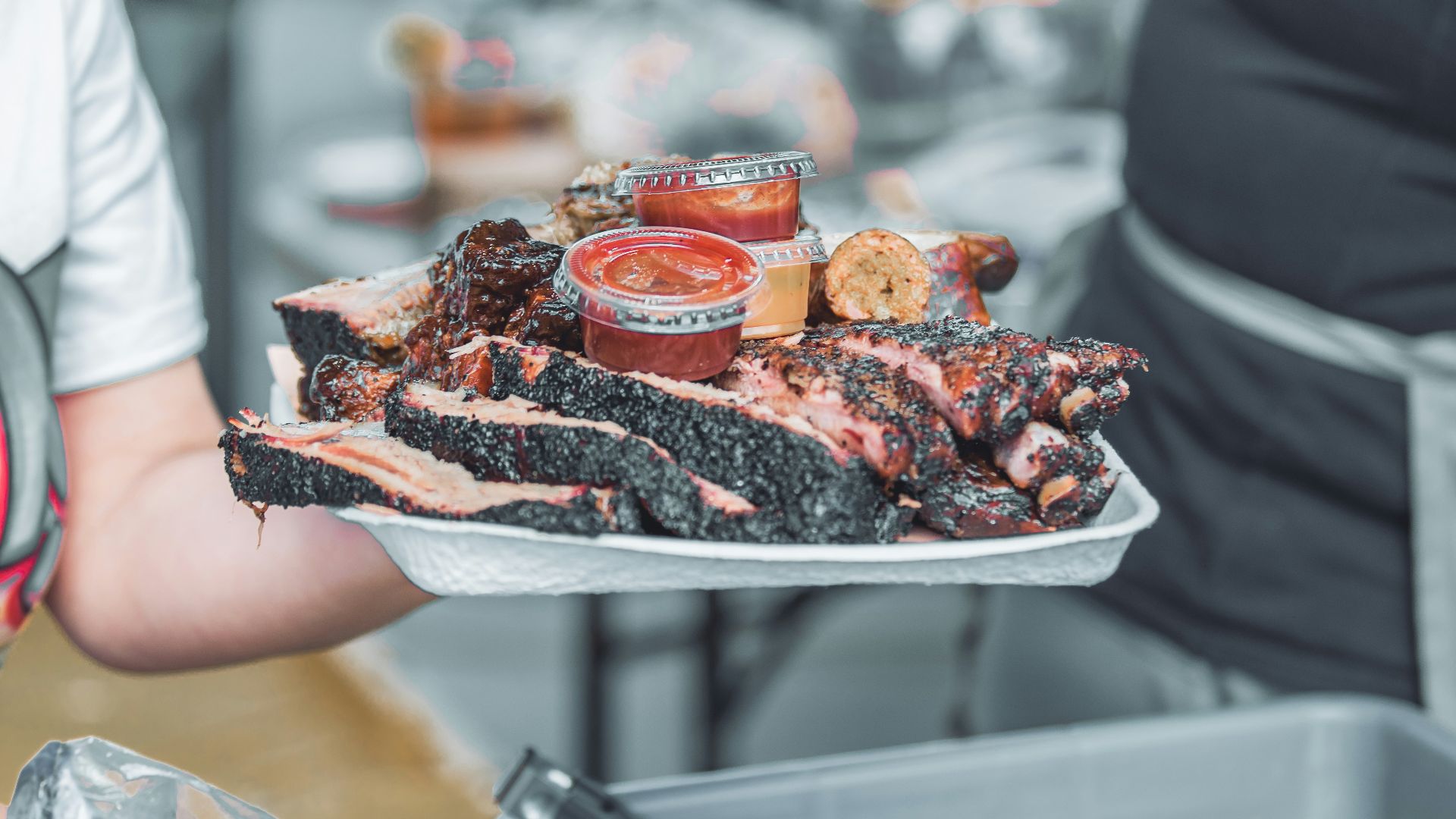 person holding white ceramic tray with sliced of pizza
