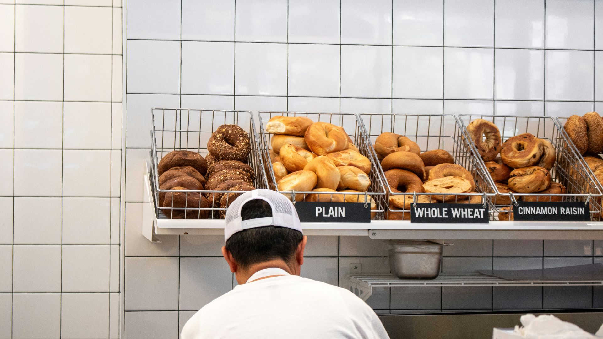 a man standing in front of a display of doughnuts
