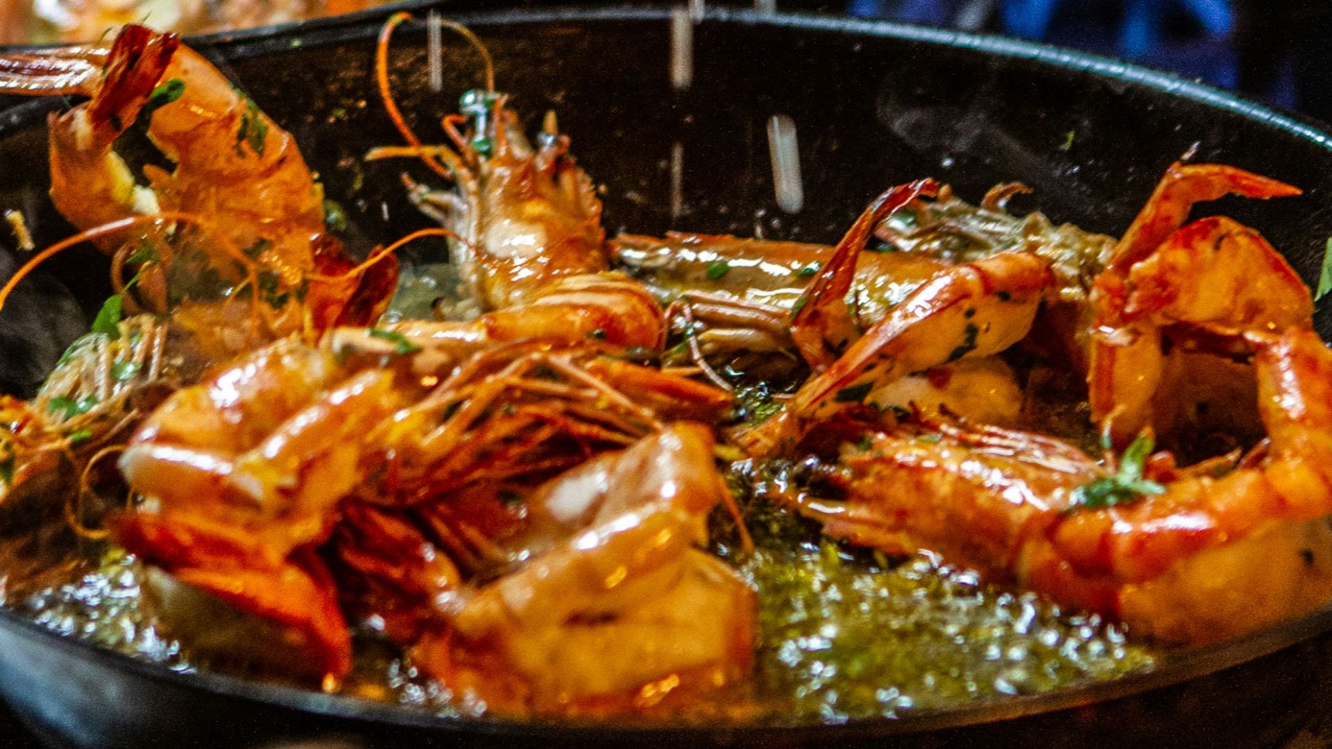 person holding stainless steel tray with cooked food