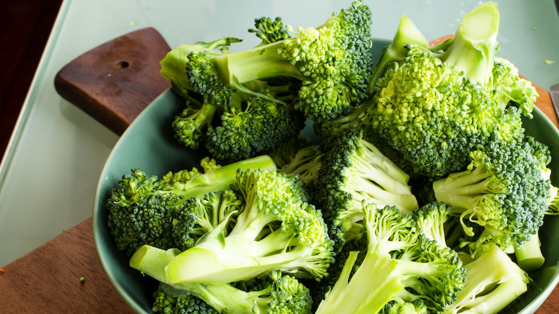 green broccoli on brown wooden chopping board