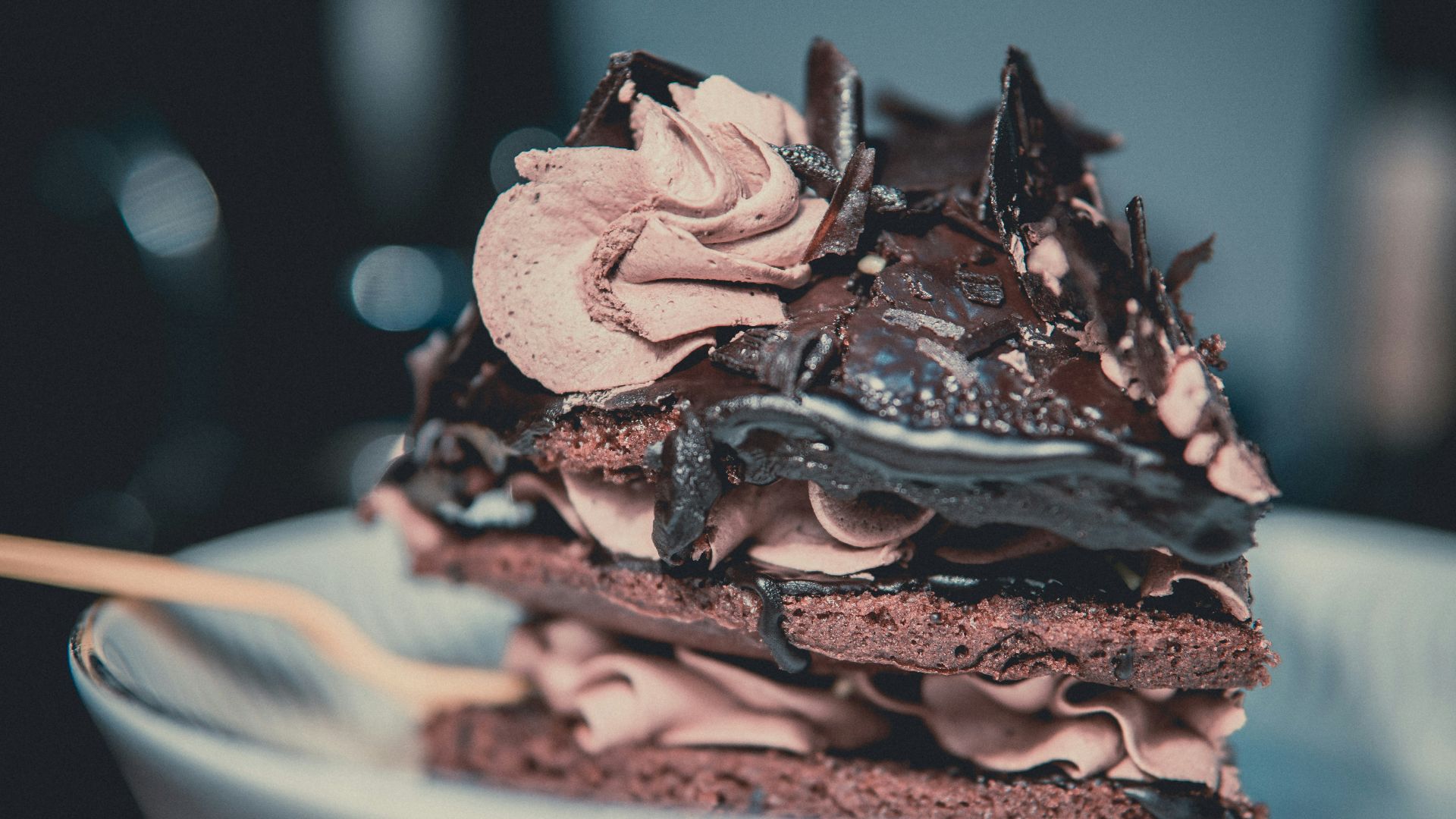 chocolate cake with blue icing on white ceramic plate