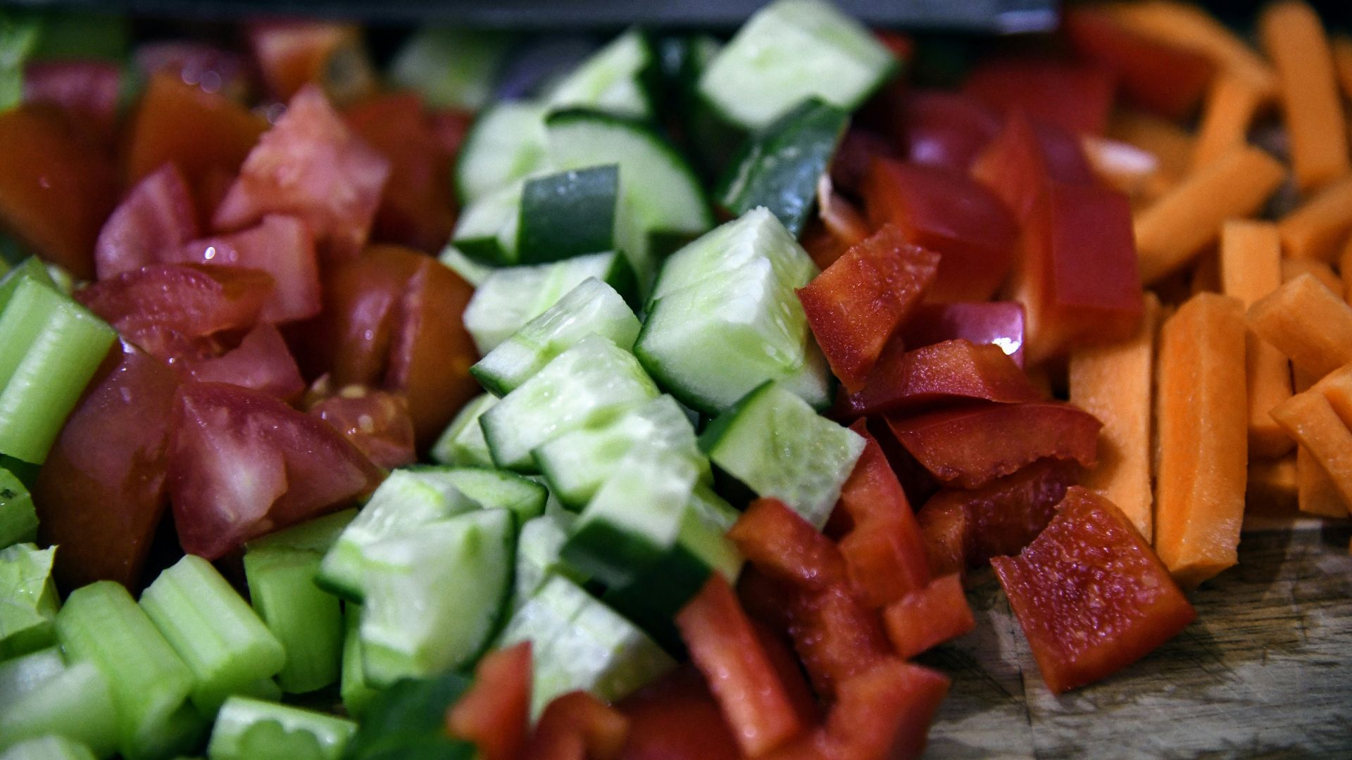 a close up of a cutting board with chopped vegetables