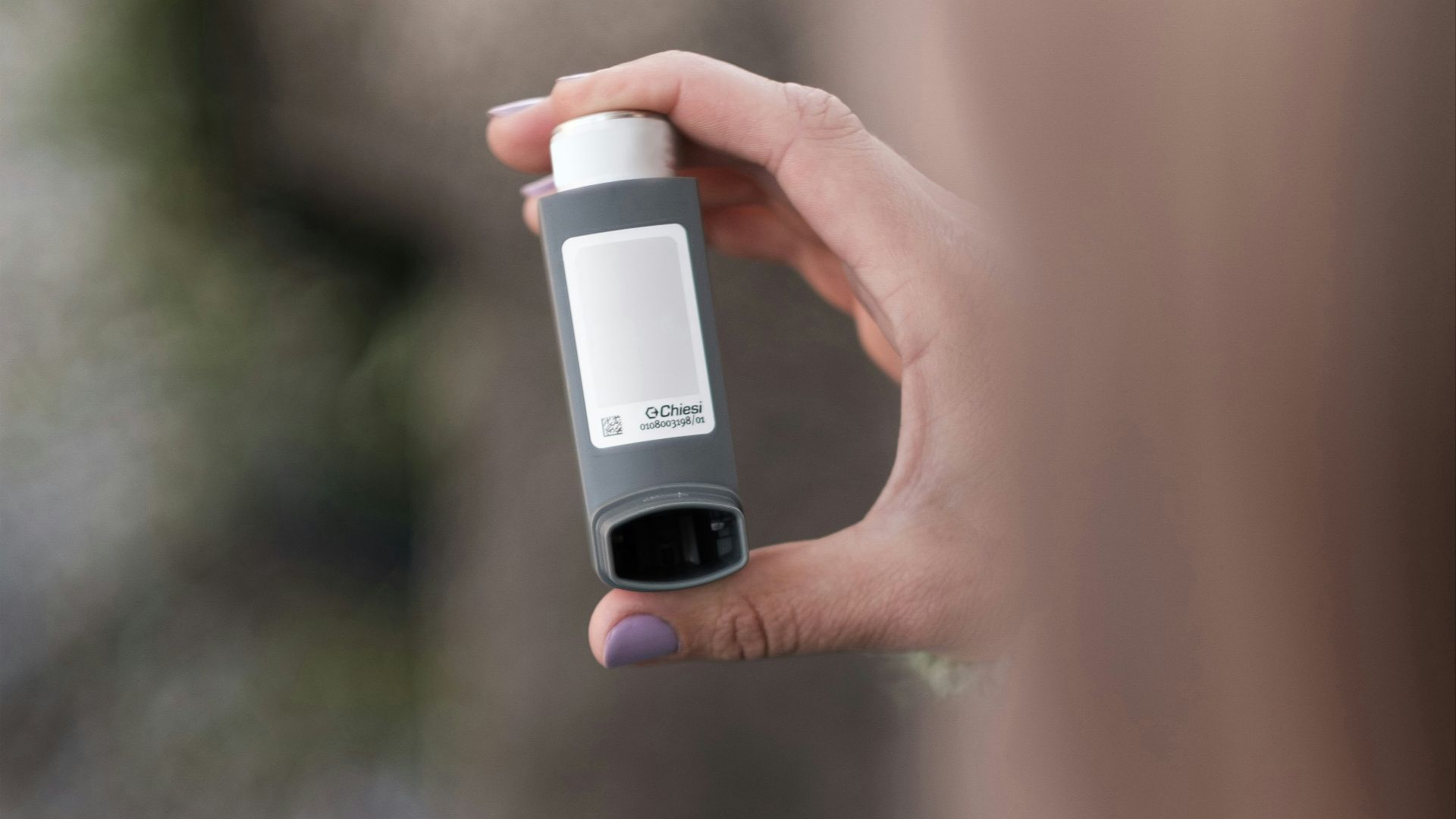 A person holding a bottle in their hand