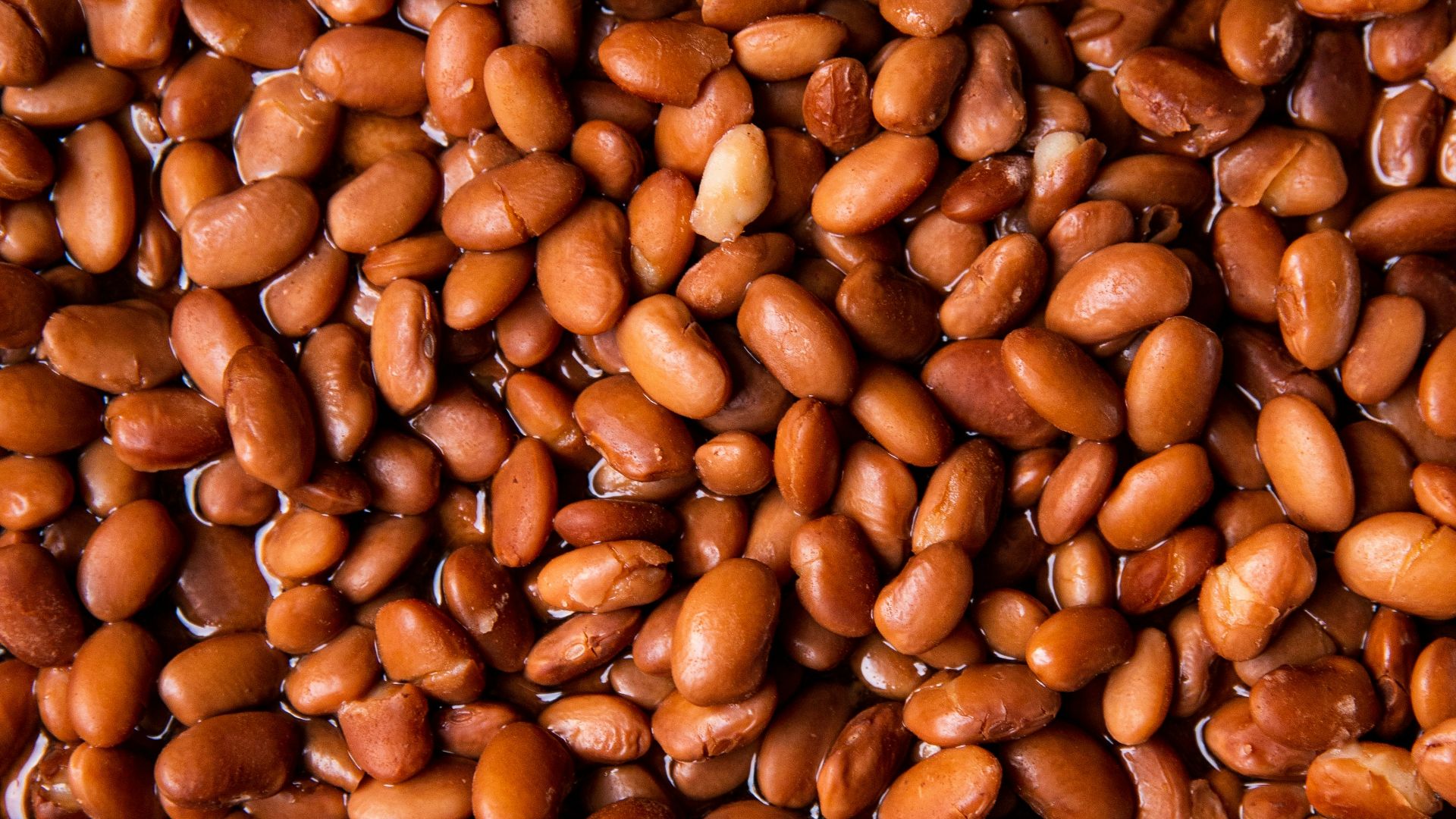 brown coffee beans on brown wooden surface