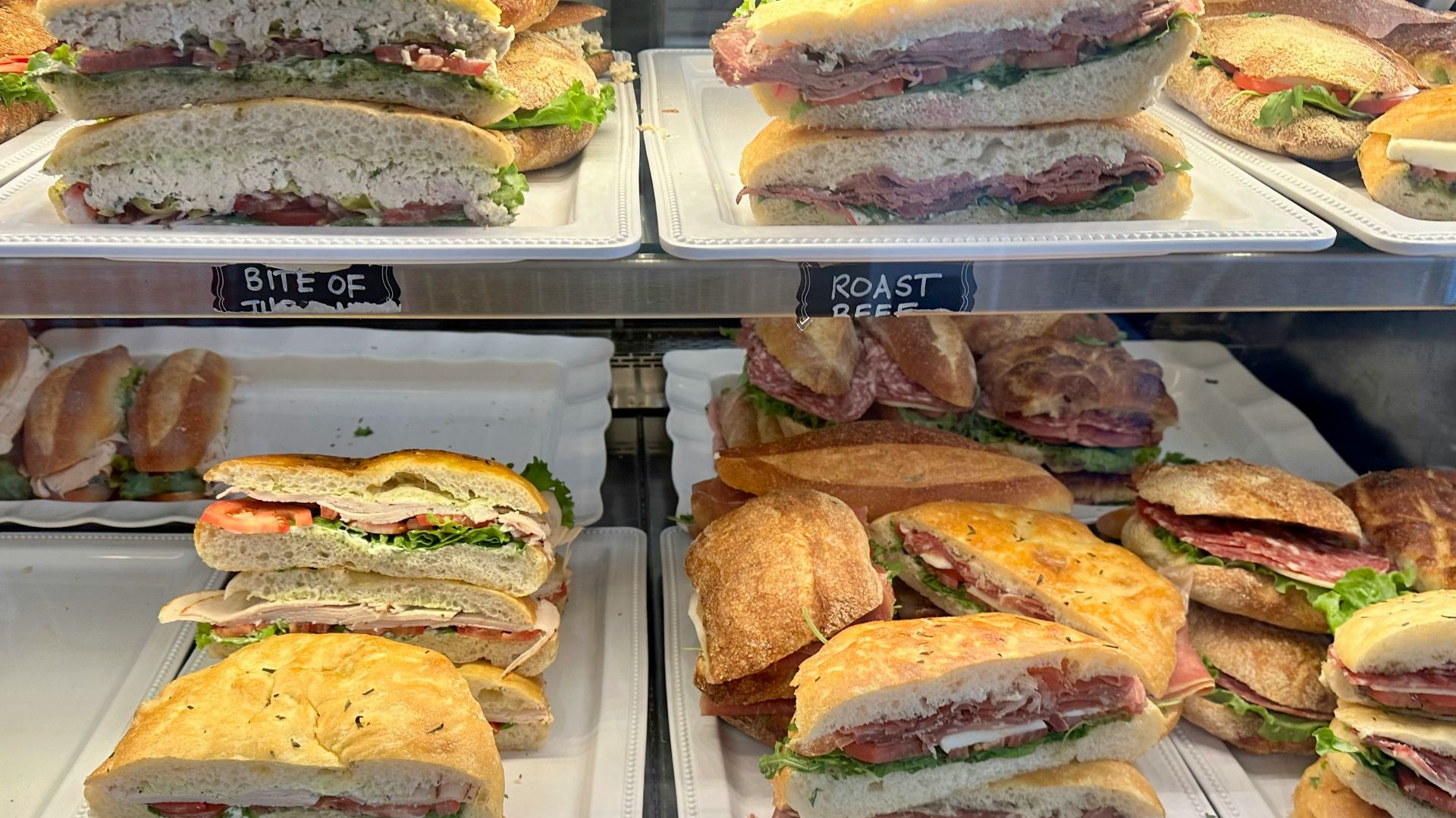 a display case filled with lots of sandwiches