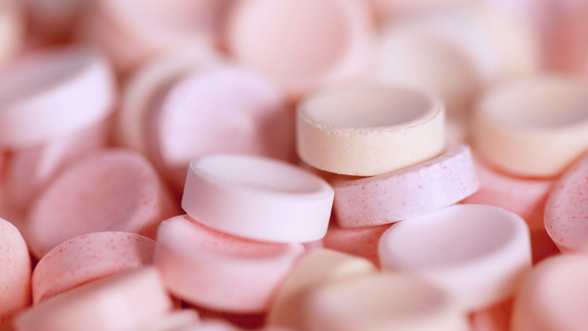 tilt-shift photography of pink medicine tablet lot