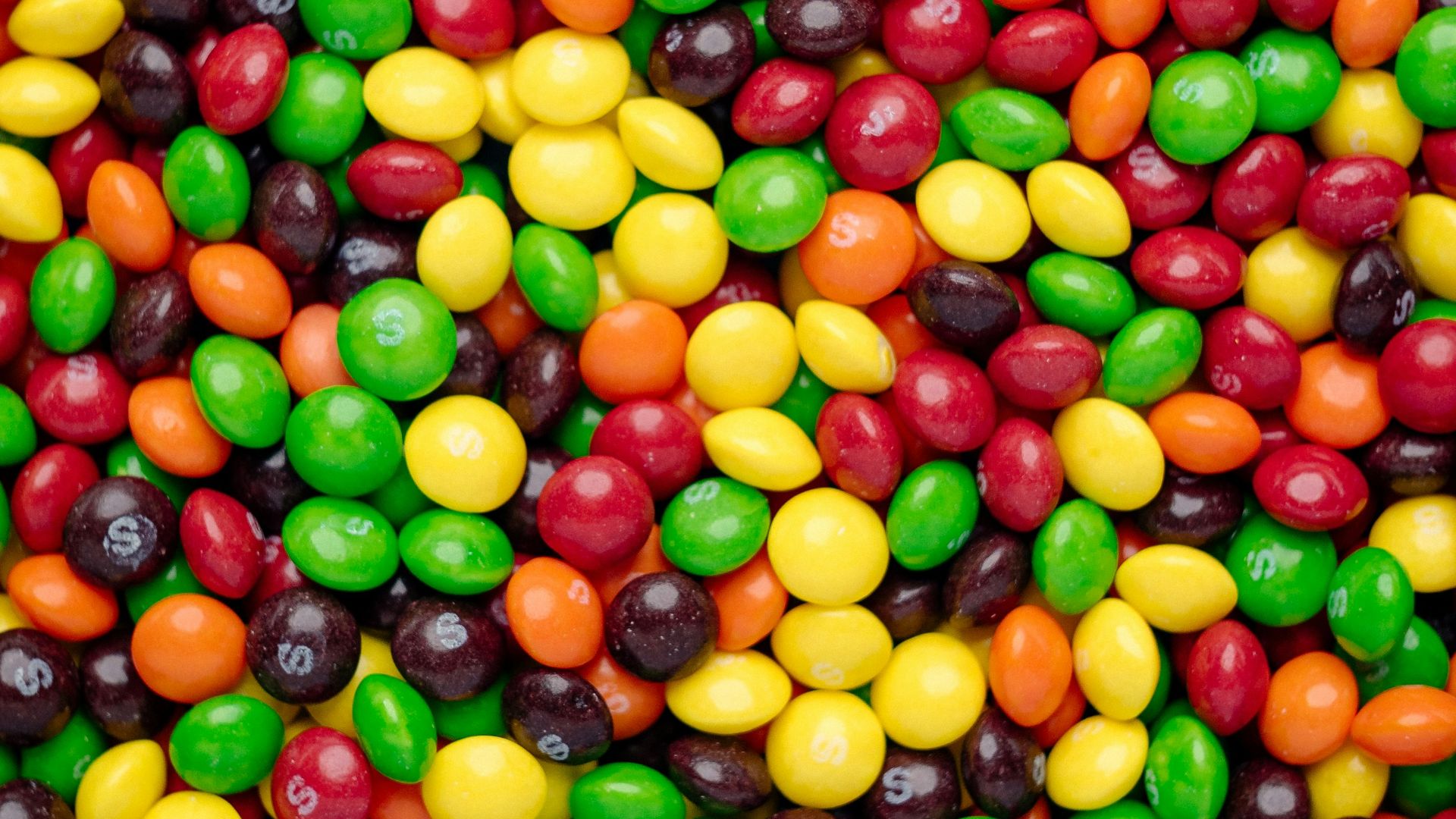 yellow red and green round fruits