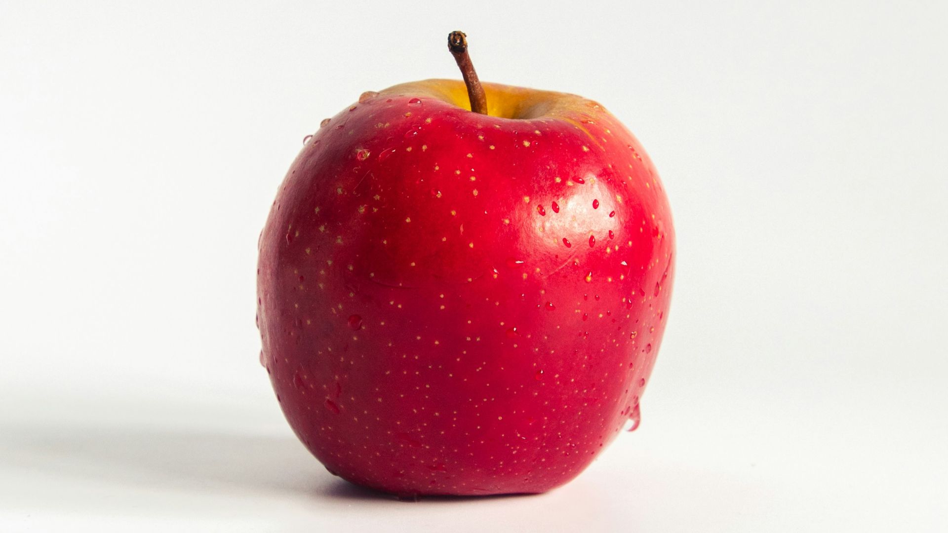 red apple on white surface