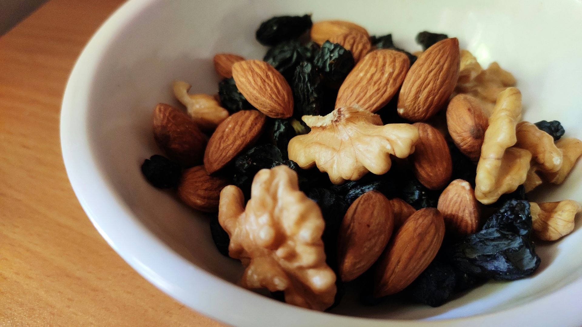brown and black nuts on white ceramic bowl