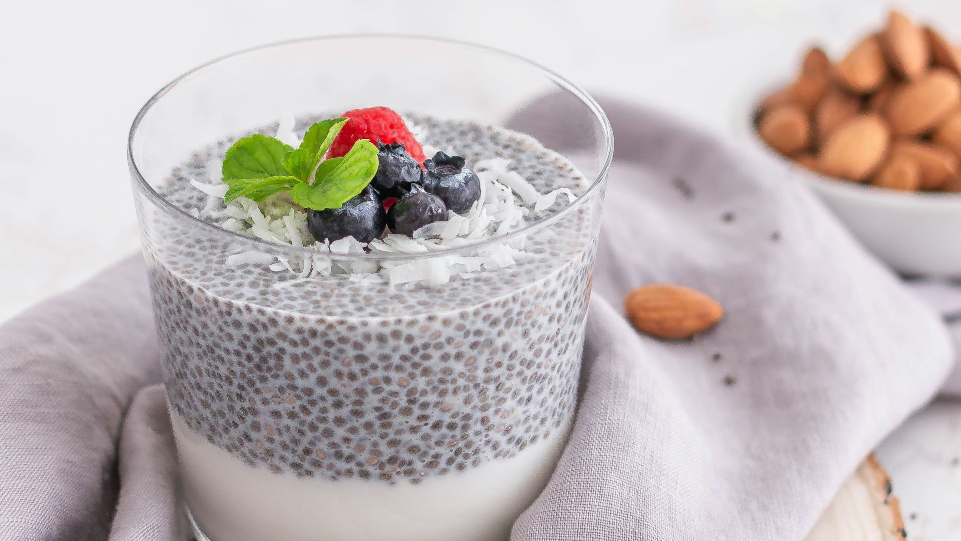 a glass of milk with berries and a spoon