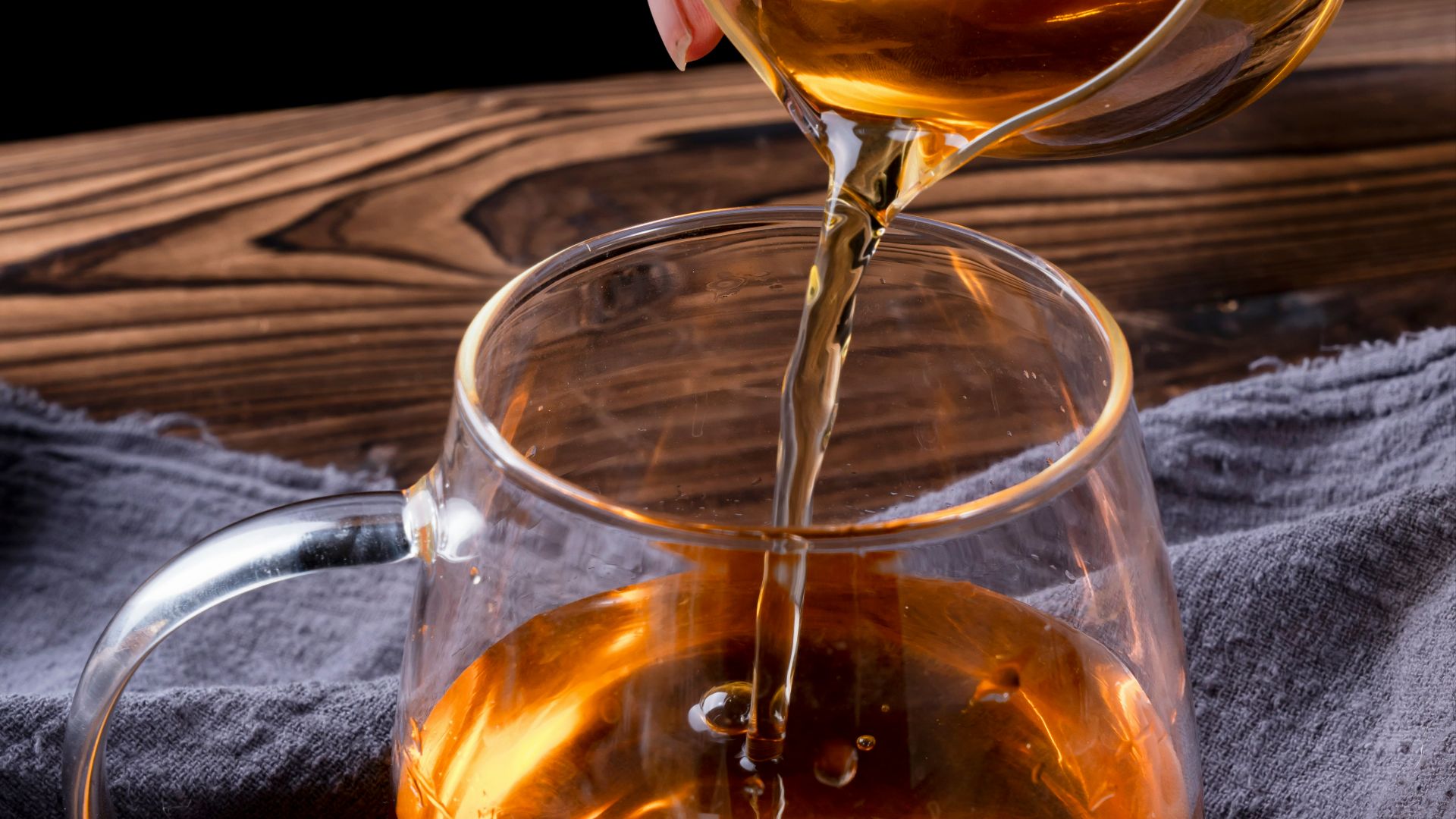 clear glass mug with brown liquid